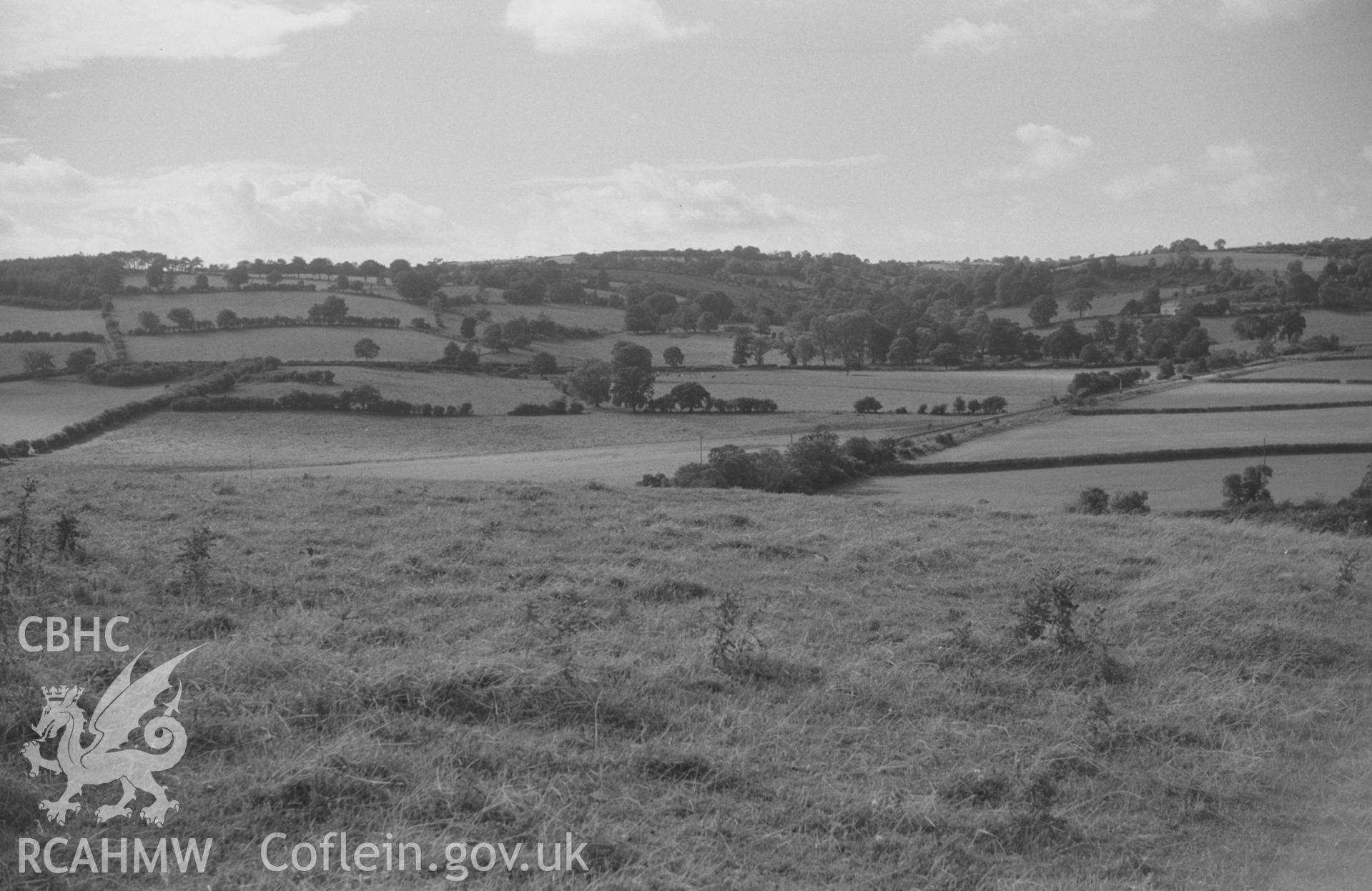 Digital copy of a black and white negative showing panoramic view of Glan Denys, Derry Ormond Monument, Dulas valley and woods by Castell Goetre. Photographed by Arthur O. Chater on 4th September 1966 from Grid Reference SN 591 505. (Photograph 6 of 6).