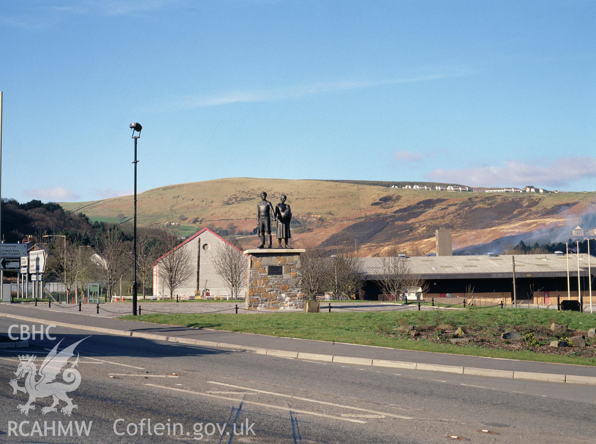 Digital copy of a colour transparency showing sculpture of a man, woman and baby at Llwynypia.