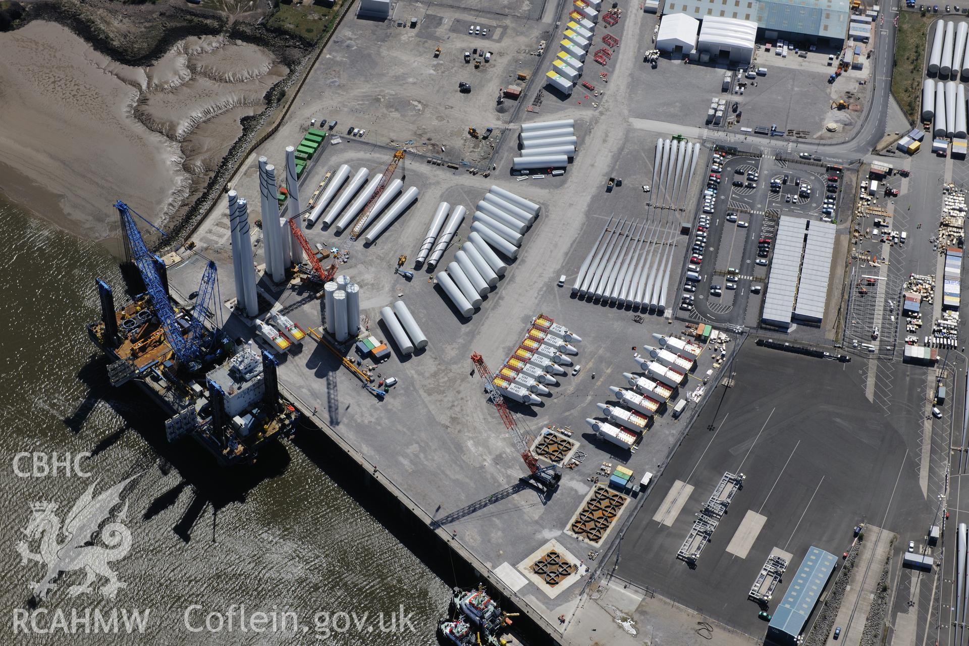 Mostyn Quay in the port of Mostyn, with windfarm parts. Oblique aerial photograph taken during the Royal Commission?s programme of archaeological aerial reconnaissance by Toby Driver on 22nd May 2013.