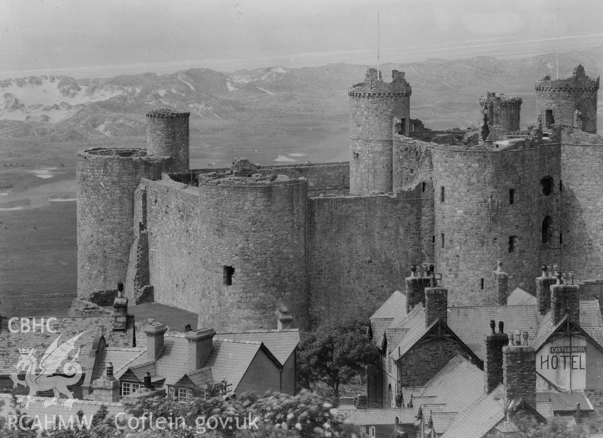 Digital copy of black and white image showing Harlech Castle: south-east view of southern side of castle and gatehouse.