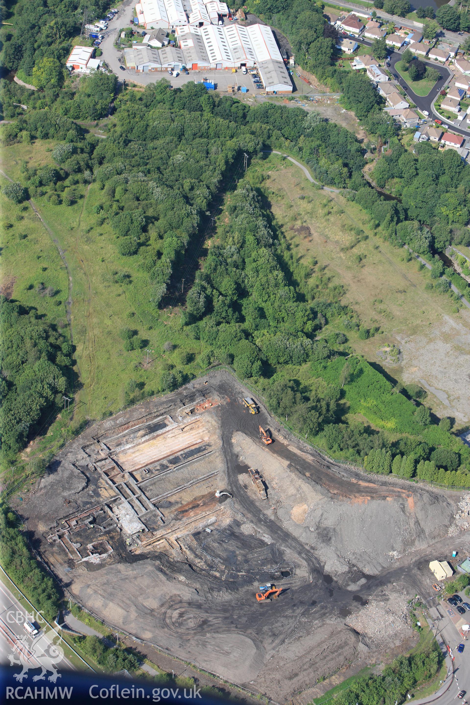 Site of former Rotax factory, and Cyfarthfa Ironworks including the remains of its blast furnaces, under excavation by Glamorgan-Gwent Archaeological Trust. Oblique aerial photograph taken during the Royal Commission?s programme of archaeological aerial reconnaissance by Toby Driver on 1st August 2013.
