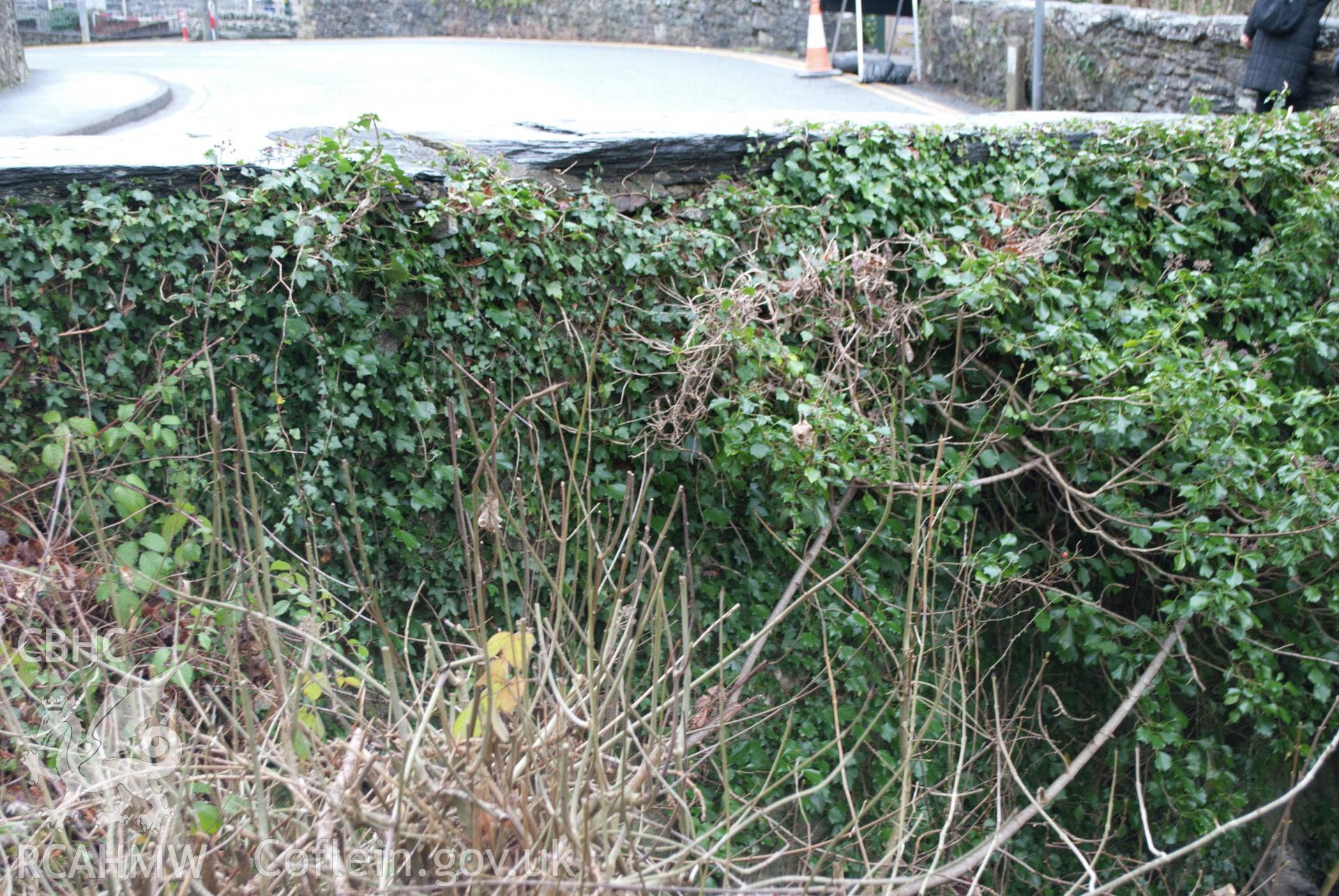 View of northwest facing side of parapet where coping stone is damaged (limited visibility). Digital photograph taken for Archaeological Watching Brief at Pont y Pair, Betws y Coed, 2019. Gwynedd Archaeological Trust Project ref G2587.