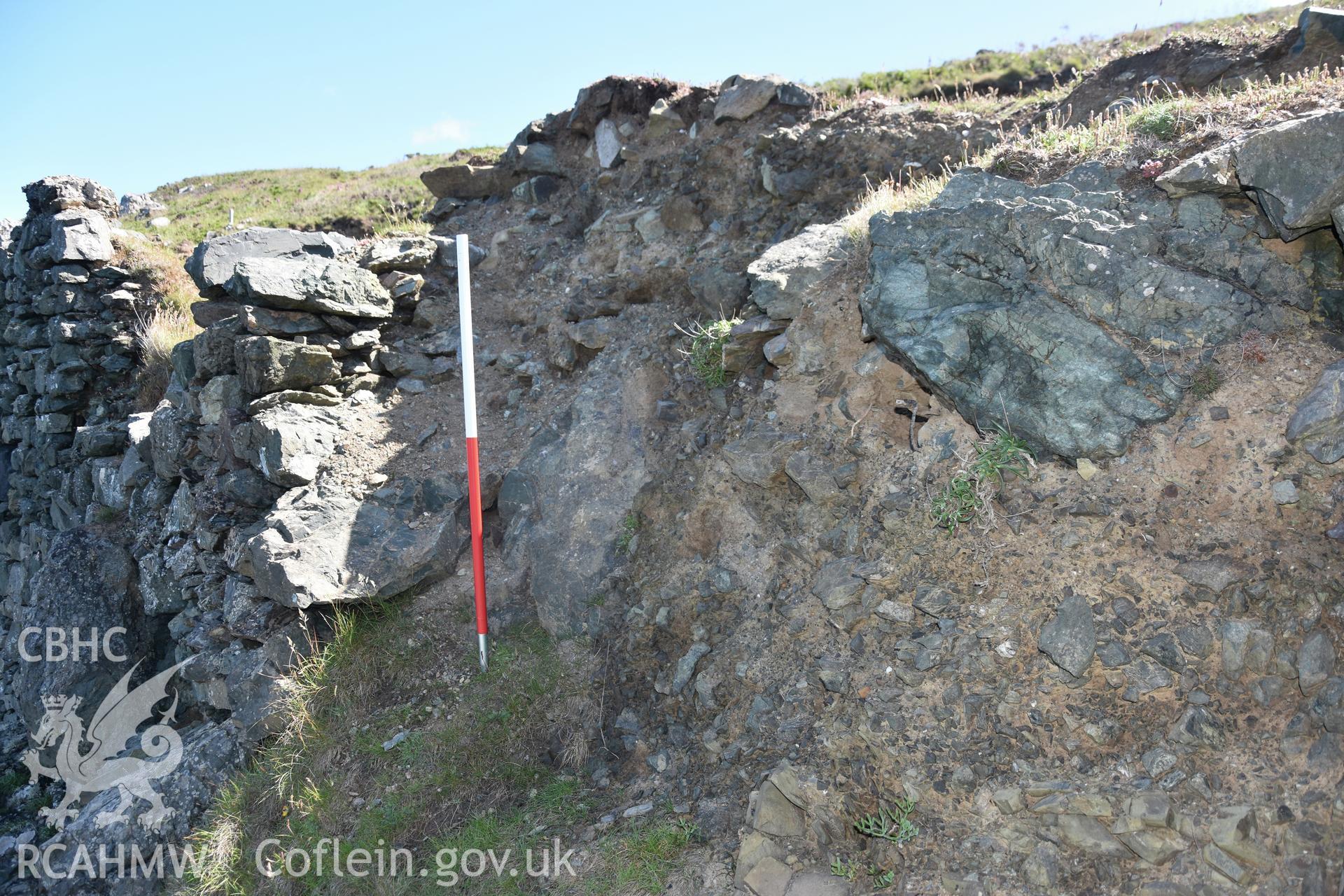 Penmaenmelyn copper mine. View of eroding west end of rectangular building at southern end of terrace. Investigator?s photographic survey for the CHERISH Project. ? Crown: CHERISH PROJECT 2019. Produced with EU funds through the Ireland Wales Co-operation Programme 2014-2020. All material made freely available through the Open Government Licence.