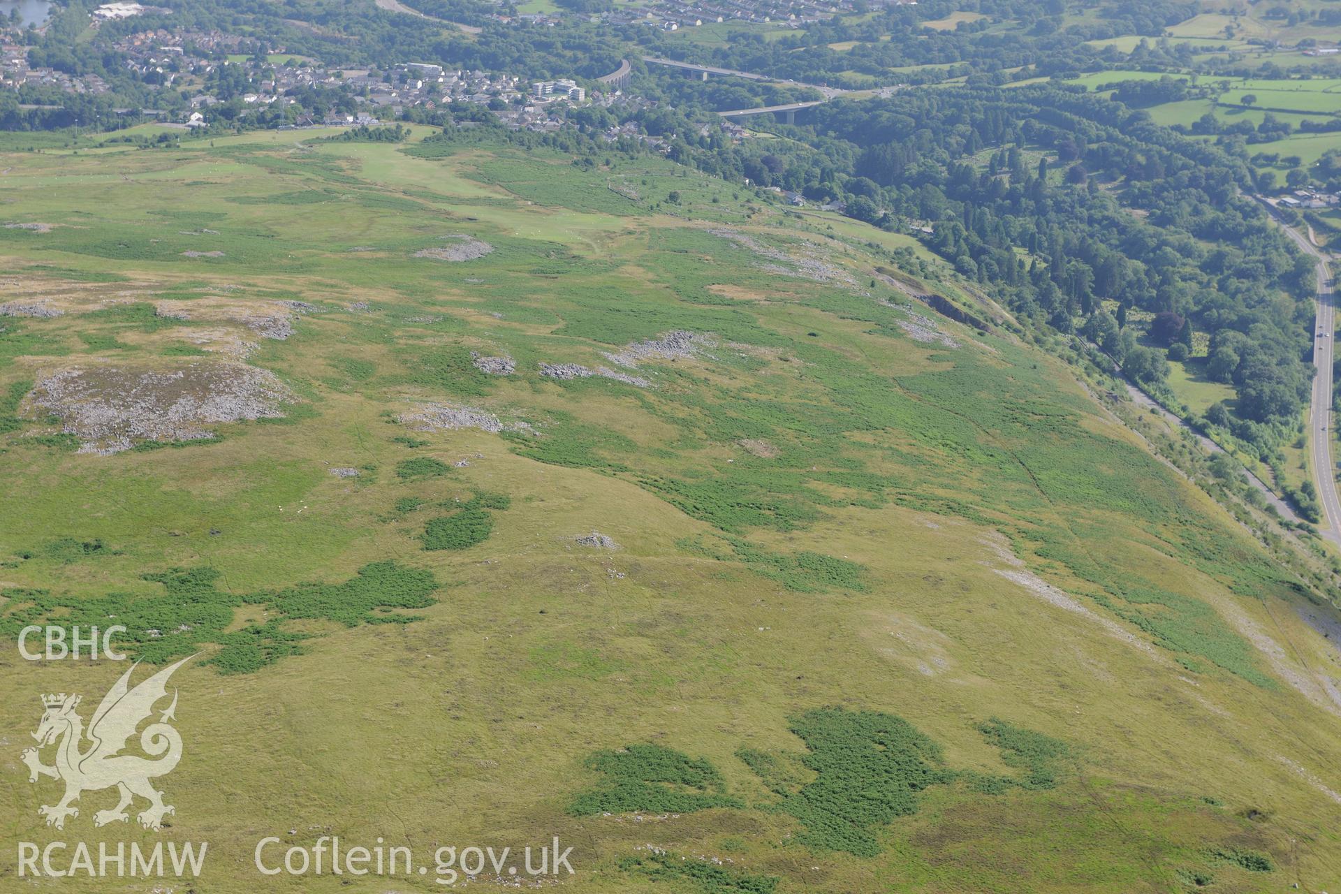Cefn Cilsanws hill, with view of the disused Danydarren quarry and the town of Cefn Coed-y-Cymer beyond. Oblique aerial photograph taken during the Royal Commission?s programme of archaeological aerial reconnaissance by Toby Driver on 1st August 2013.