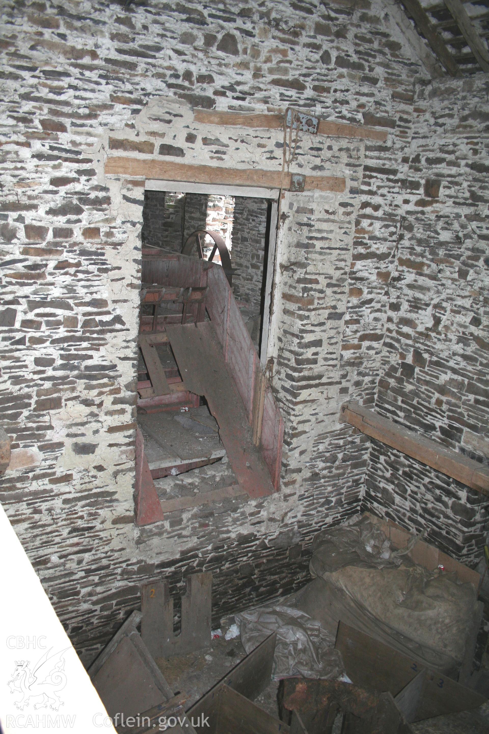 Interior view showing dissused iron machinery. Photographic survey of the threshing house, straw house, mixing house and root house at Tan-y-Graig Farm, Llanfarian, conducted by Geoff Ward and John Wiles, 11th December 2006.