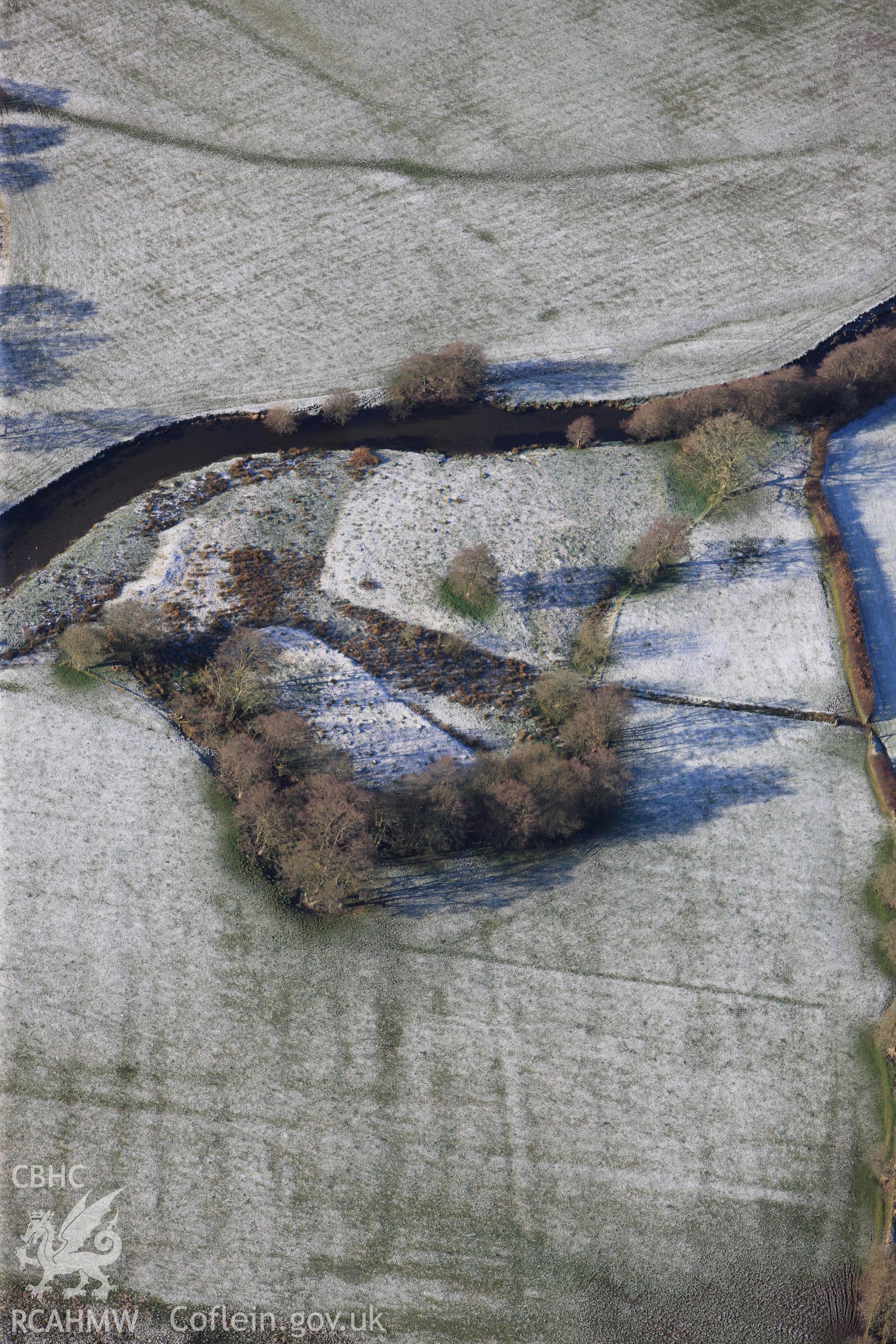 Riverside earthworks to the south-east of Caerau Roman Fort, Beulah, west of Builth Wells. Oblique aerial photograph taken during the Royal Commission?s programme of archaeological aerial reconnaissance by Toby Driver on 15th January 2013.