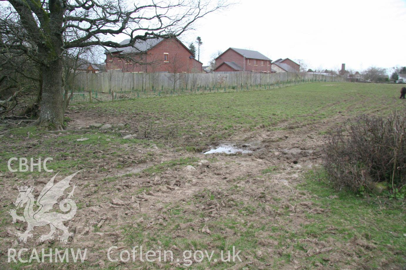 'Break in field's eastern boundary (looking north-west).' Digital colour photograph taken during site visit to land south of school lane, Penperlleni. Part of Archaeological Desk Based Assessment conducted by Iestyn Jones of Archaeology Wales, 2014.