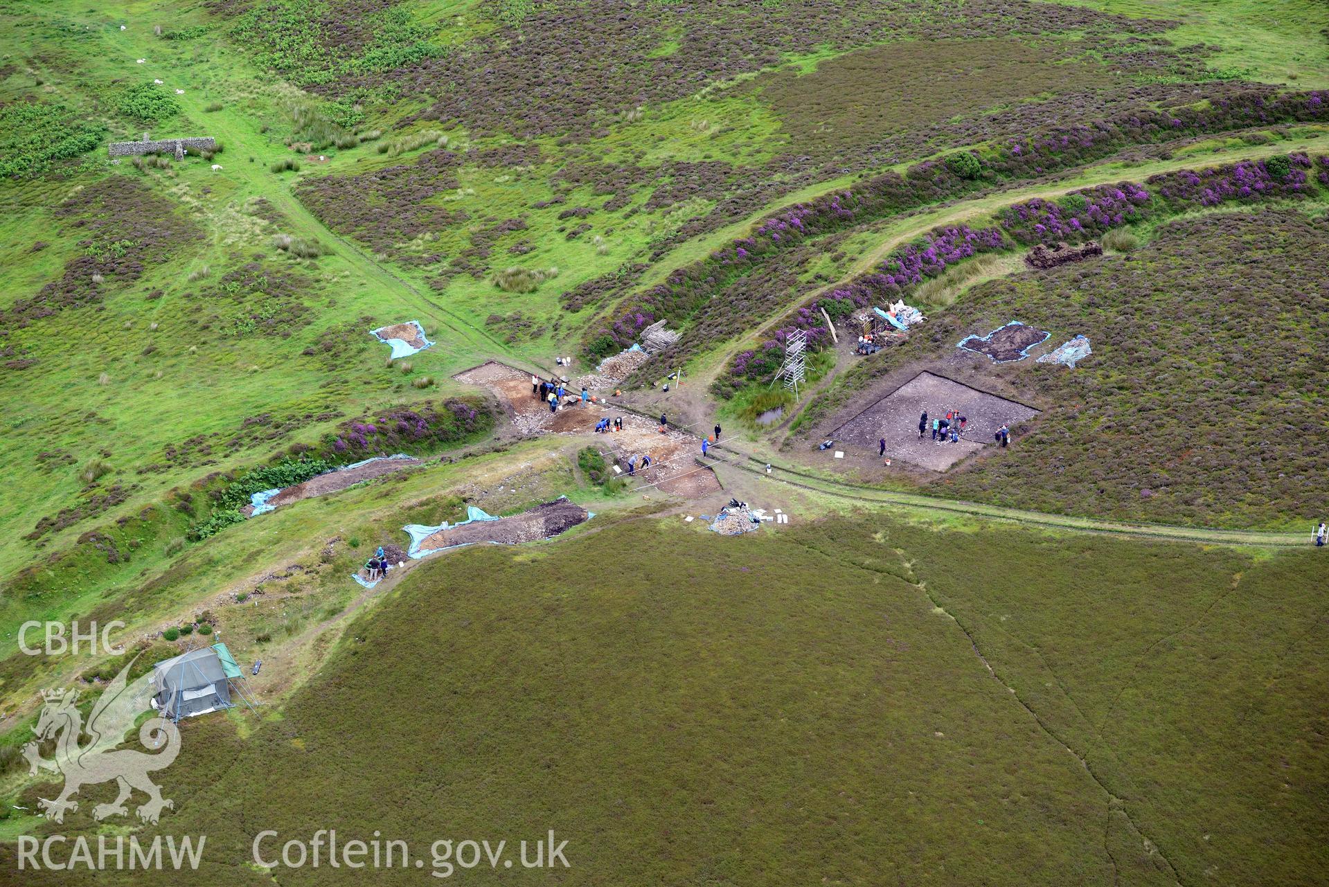 Penycloddiau Hilfort and Hut Platform V, Llangwyfan. Excavation by Liverpool University. Oblique aerial photograph taken during the Royal Commission's programme of archaeological aerial reconnaissance by Toby Driver on 30th July 2015.