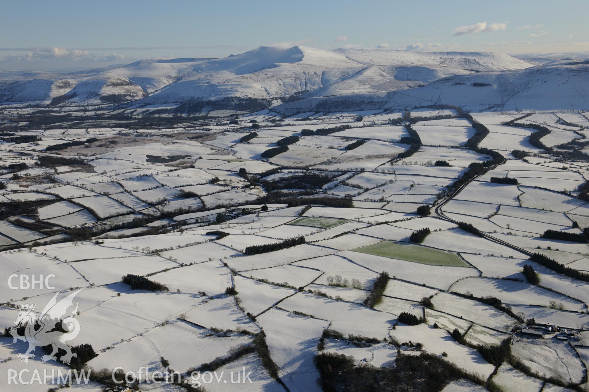 The summits of Corn Du and Pen-y-Fan in the Brecon Beacons, viewed from the north west. Oblique aerial photograph taken under snowy conditions during the Royal Commission?s programme of archaeological aerial reconnaissance by Toby Driver on 15th January 2013.