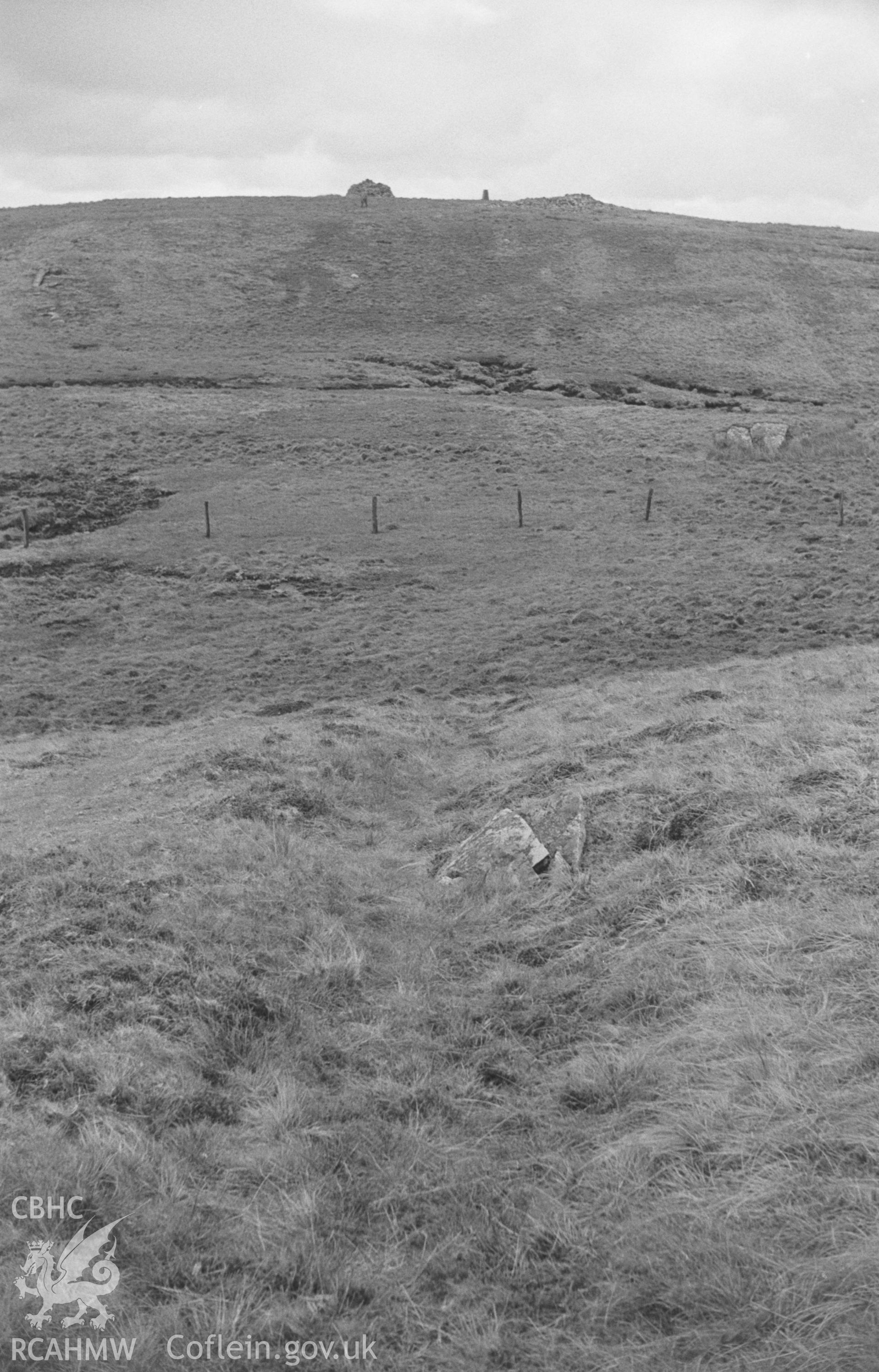 Digital copy of black & white negative showing view looking along the ditch of Gwys-yr-Ychen-Bannog across peat bog to the two large cairns at Garn Gron, near Tregaron. Photographed by Arthur O. Chater in April 1966 looking east south east from SN 738 612.