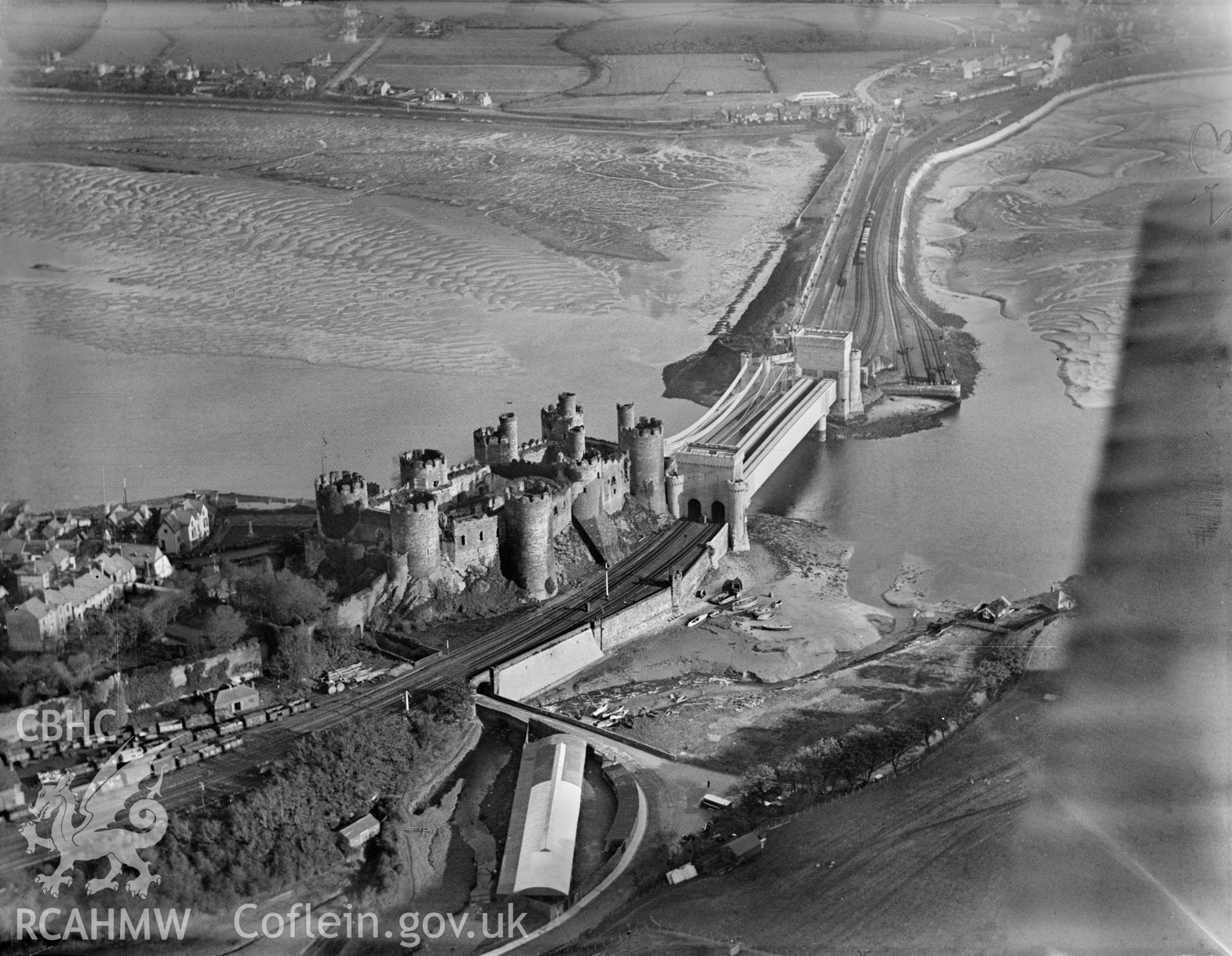 Conwy castle, railway and suspension bridges, oblique aerial view. 5?x4? black and white glass plate negative.