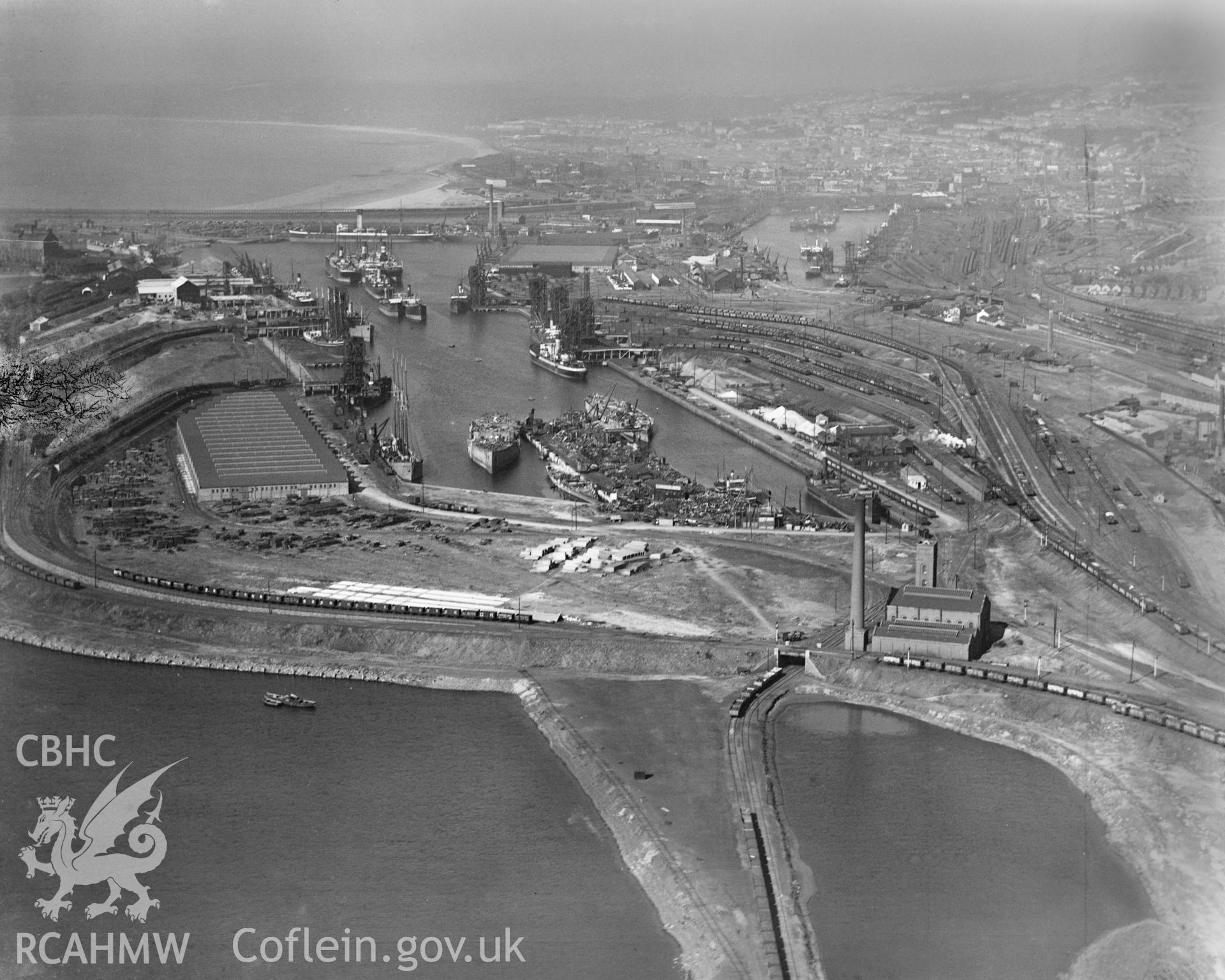 View of Swansea docks showing T. W. Ward's new scrapping berth at the eastern end of Kings Dock, oblique aerial view. 5?x4? black and white glass plate negative.