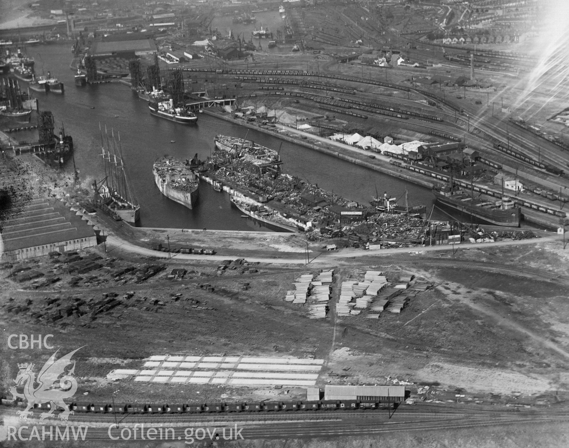 Black and white oblique aerial photograph showing Swansea Docks, from Aerofilms album Swansea (W30), taken by Aerofilms Ltd and dated 1921.