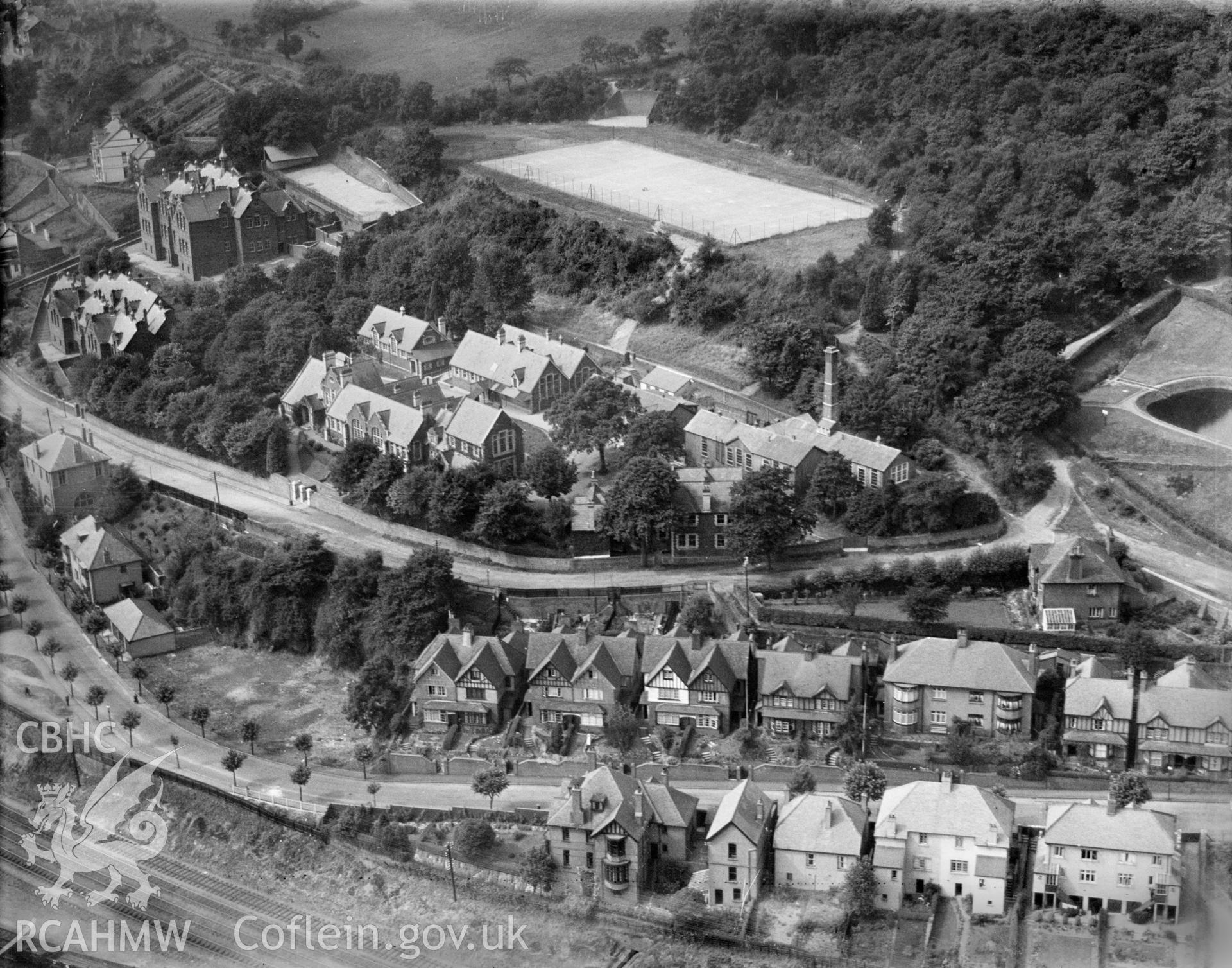 View of Pontypridd showing Grammar school, handball court, tennis courts and Lan Wood reservoir, oblique aerial view. 5?x4? black and white glass plate negative.