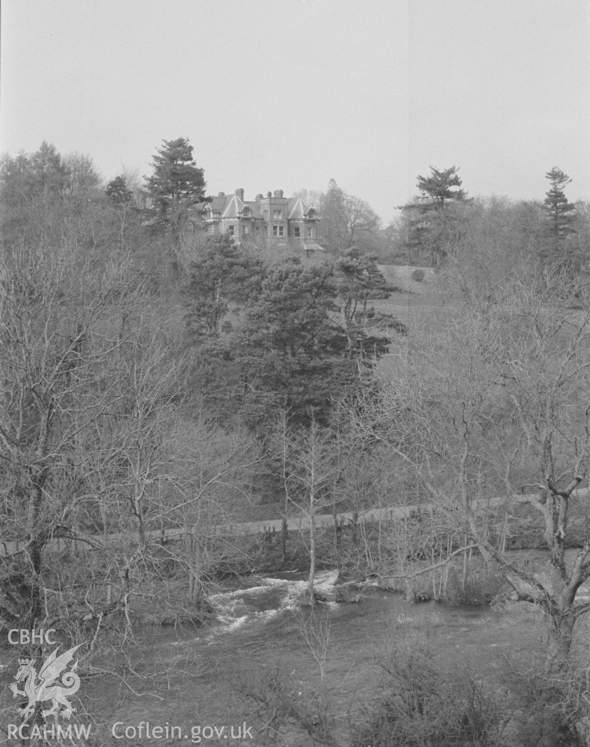 Digital copy of a black and white negative showing Cilgwyn, Newcastle Emlyn, looking across the Teifi from the castle earthworks. Photographed by Arthur O. Chater in April 1966 looking north east from Grid Reference SN 312 407.