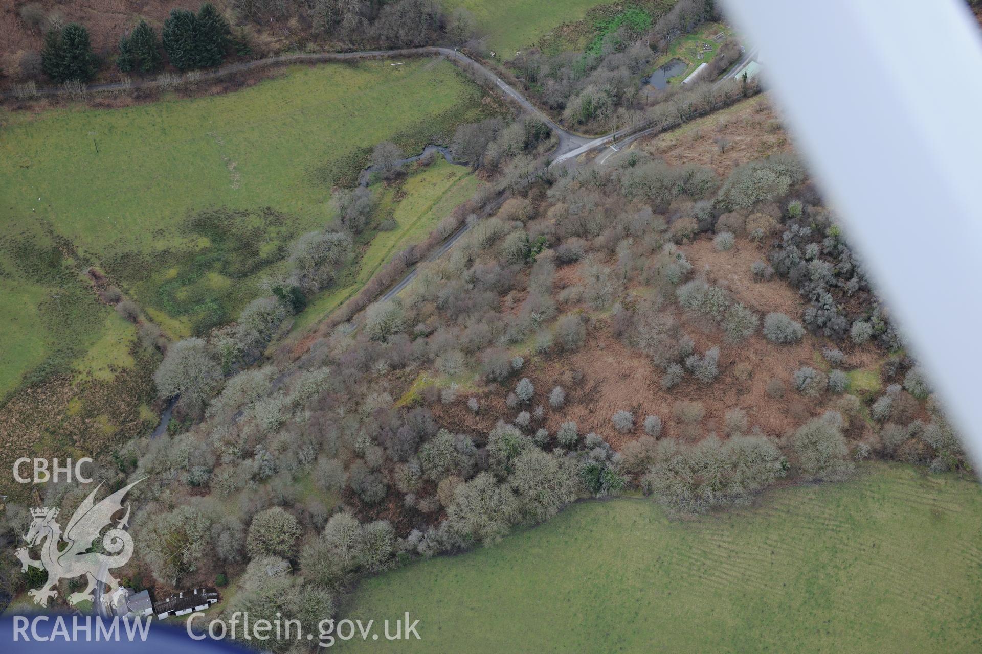 Gaer Troed-y-Rhiw defended enclosure and Melin Cwm-Hayar corn mill, near Llandysul. Oblique aerial photograph taken during the Royal Commission's programme of archaeological aerial reconnaissance by Toby Driver on 13th March 2015.