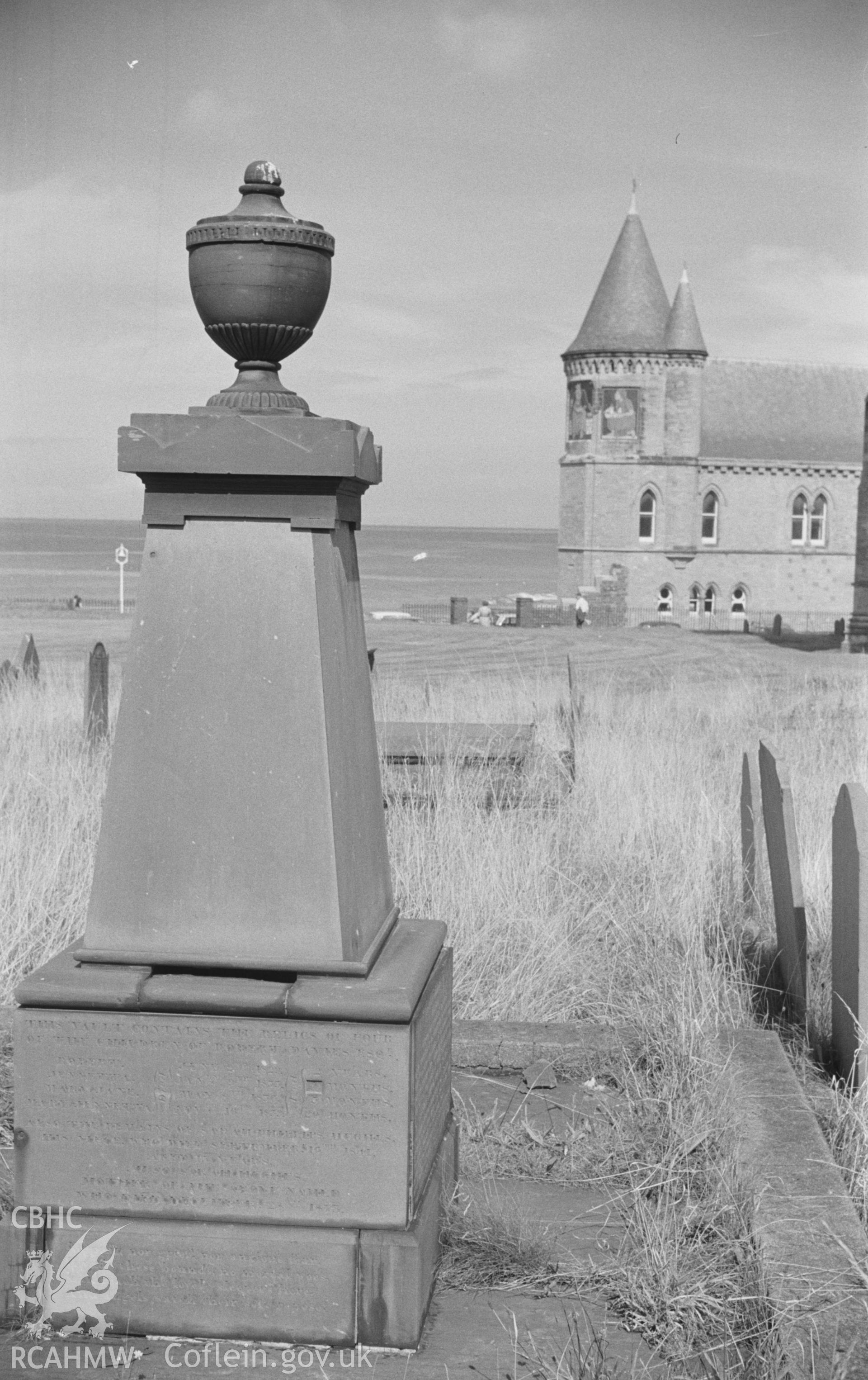 Digital copy of a black and white negative showing grave in St. Michael's church graveyard with the Old College in the background, Aberystwyth. Photographed by Arthur O. Chater in August 1966.