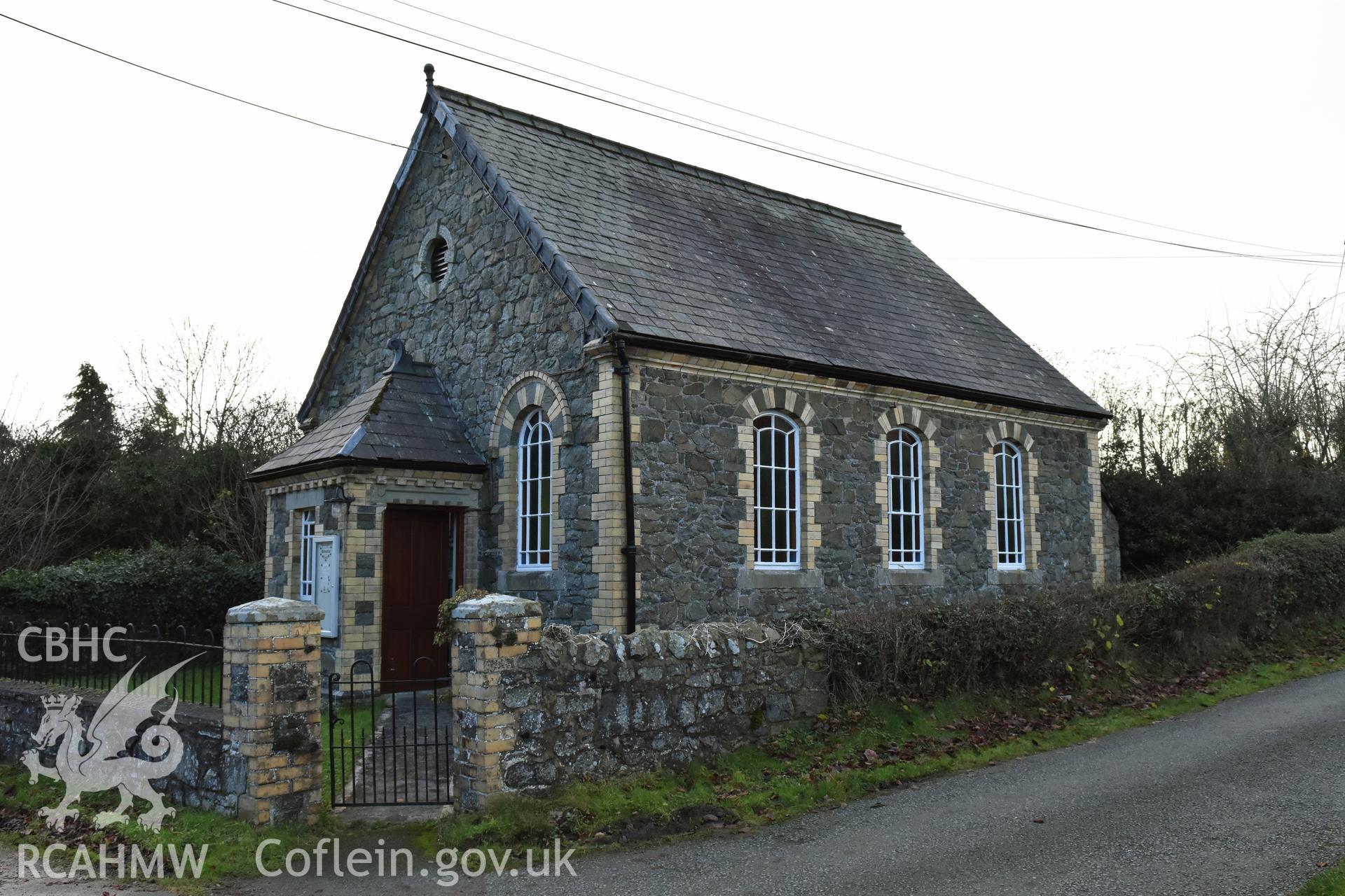 View from the north showing exterior side elevation of Hyssington Primitive Methodist Chapel, Hyssington, Churchstoke, including the front gable and entrance. Photographic survey conducted by Sue Fielding on 7th December 2018.