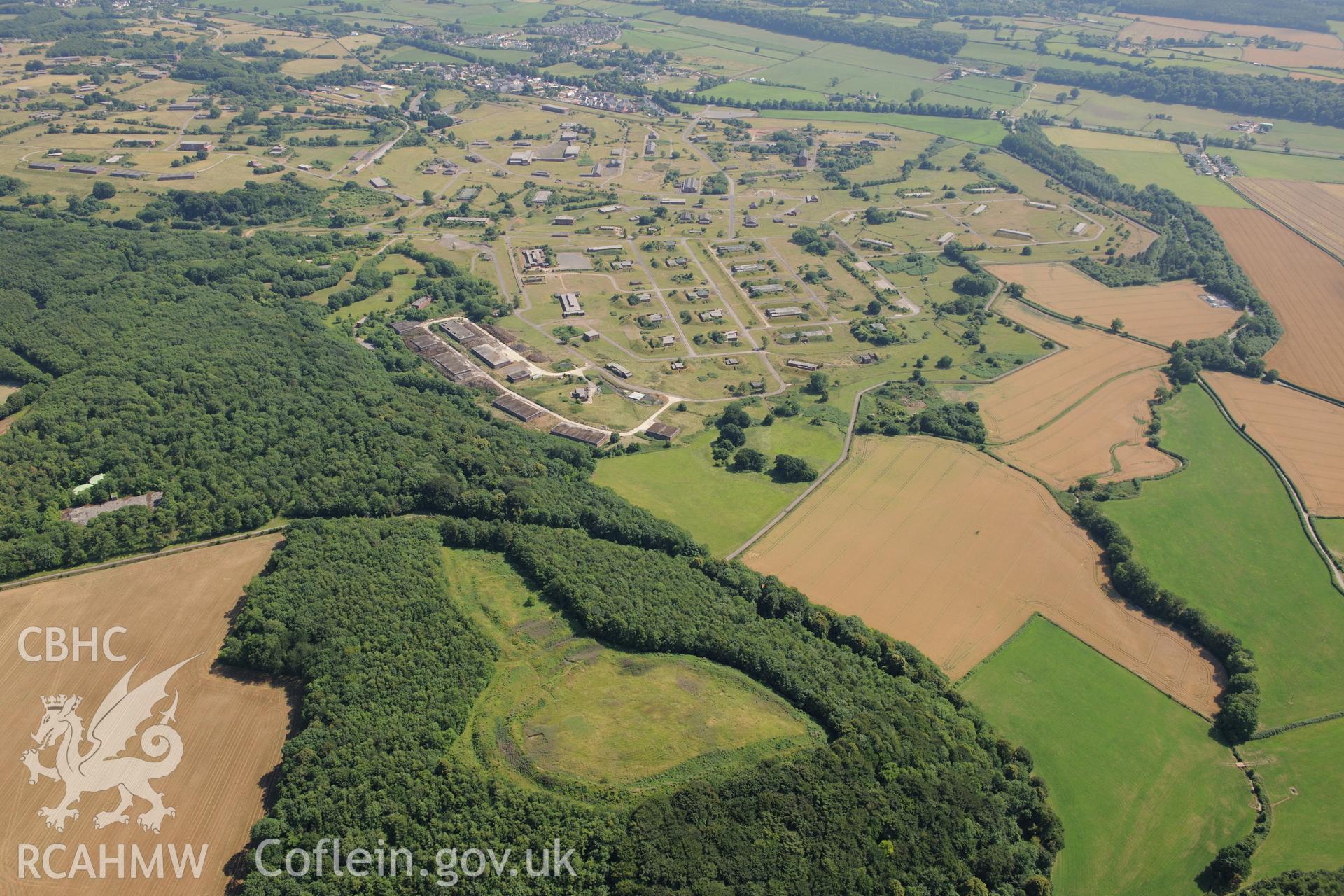 Llanmelin Wood hillfort and the Royal Naval Propellant Factory at Caerwent, west of Chepstow. Oblique aerial photograph taken during the Royal Commission?s programme of archaeological aerial reconnaissance by Toby Driver on 1st August 2013.