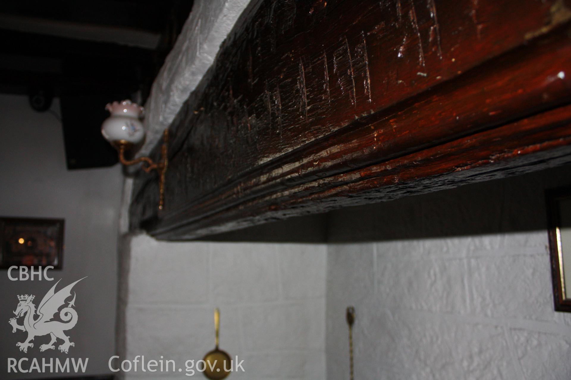 Colour photograph showing detail of wood beam above fireplace at the Hope and Anchor at 94 Vale Street, Denbigh, Photographed during survey conducted by Geoff Ward on 7th January 2012.
