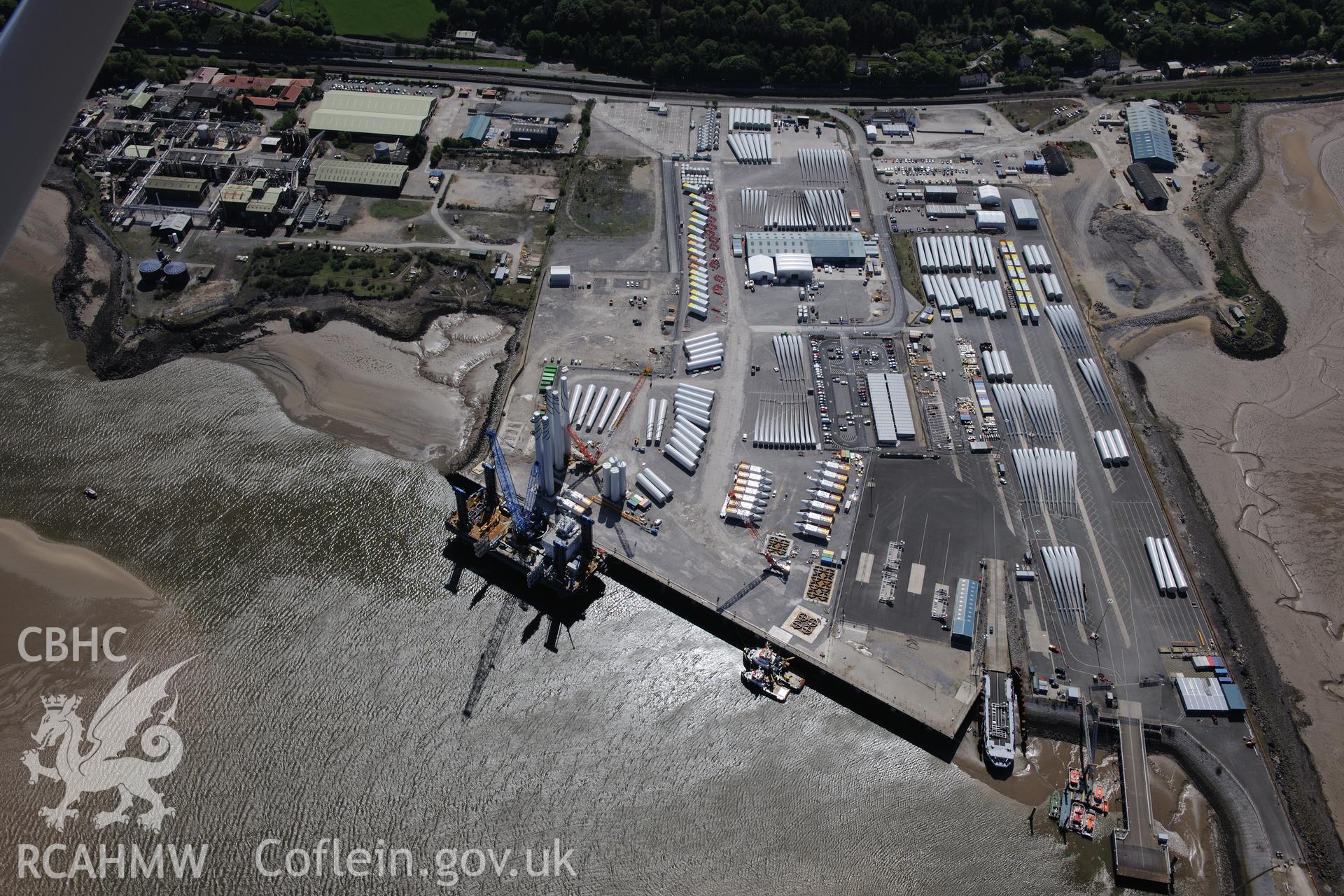 Mostyn Quay in the port of Mostyn, with windfarm parts. Oblique aerial photograph taken during the Royal Commission?s programme of archaeological aerial reconnaissance by Toby Driver on 22nd May 2013.