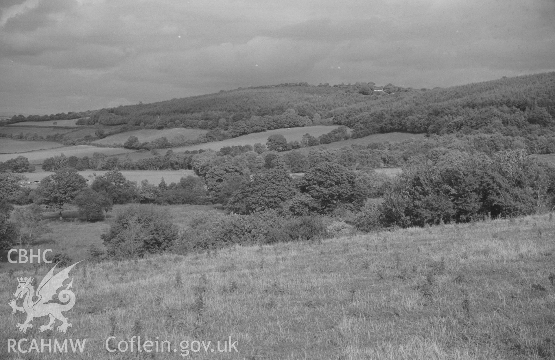 Digital copy of a black and white negative showing panoramic view of Glan Denys, Derry Ormond Monument, Dulas valley and woods by Castell Goetre. Photographed by Arthur O. Chater on 4th September 1966 from Grid Reference SN 591 505. (Photograph 1 of 6).