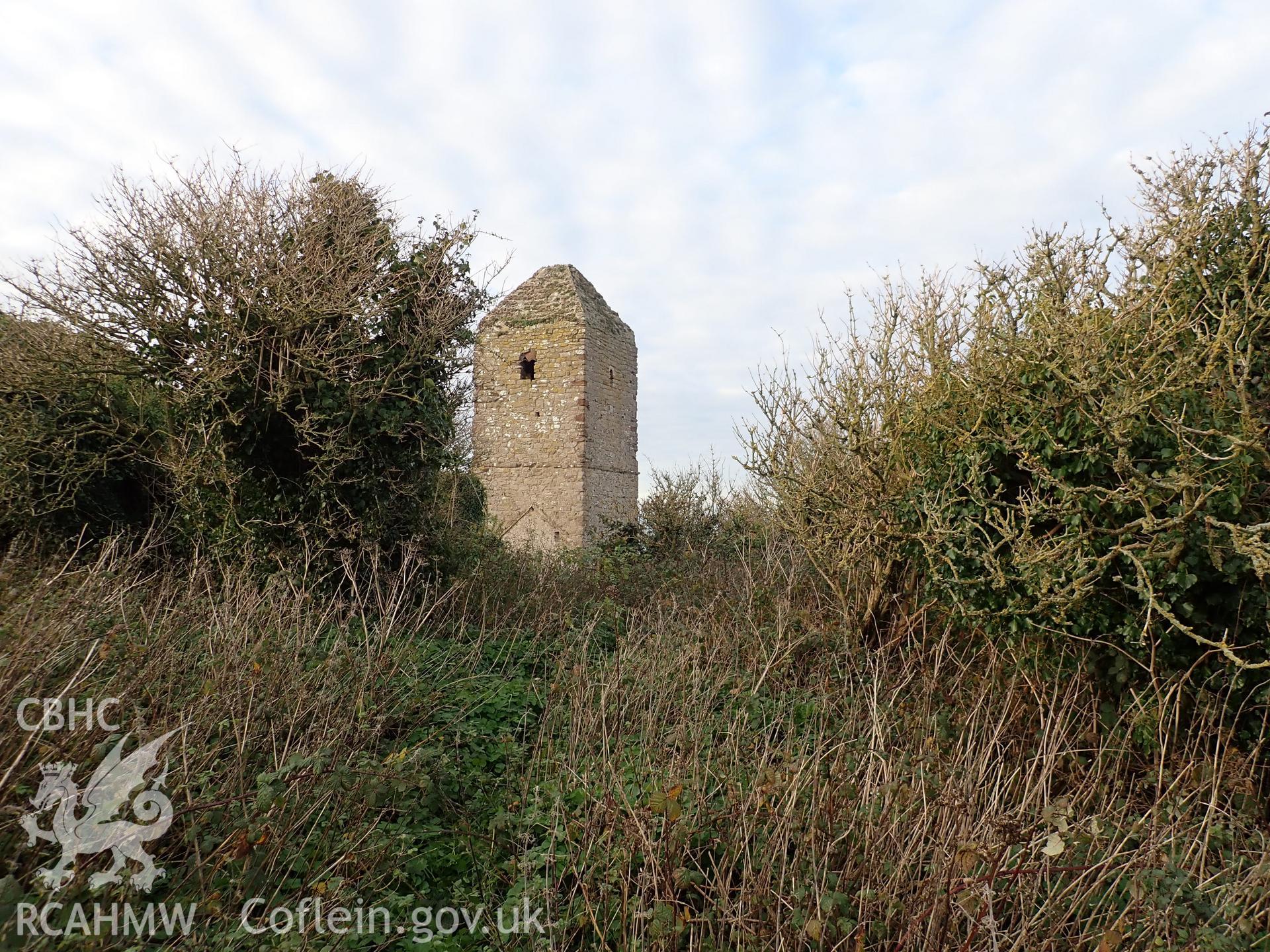 Investigator's photographic survey of the church on Puffin Island or Ynys Seiriol for the CHERISH Project. Winter view of church tower from south-east, showing overgrown environs. ? Crown: CHERISH PROJECT 2018. Produced with EU funds through the Ireland Wales Co-operation Programme 2014-2020. All material made freely available through the Open Government Licence.