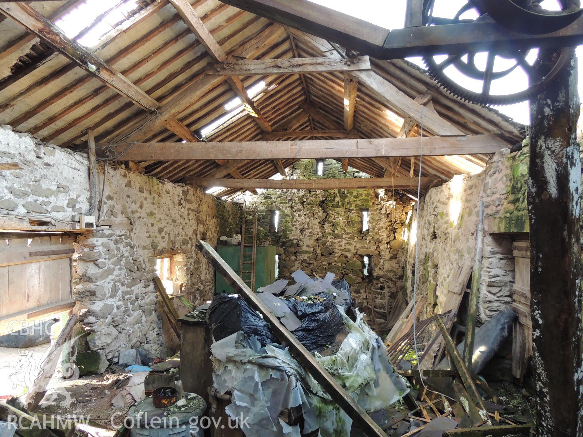View of barn interior, looking west. Photograph taken as part of archaeological building survey conducted at Bryn Gwylan Threshing Barn, Llangernyw, Conwy, carried out by Archaeology Wales, 2017-2018. Report no. 1640. Project no. 2578.