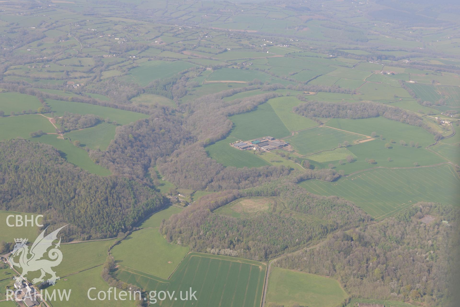 Great Llanmelin, Llanmelin Wood Hillfort and lesser enclosure, Cewre Quarry and Limekiln, Old Cwm Mill, Lower Cwm Mill and The Coombe Garden. Oblique aerial photograph taken during the Royal Commission's programme of archaeological aerial reconnaissance by Toby Driver on 21st April 2015