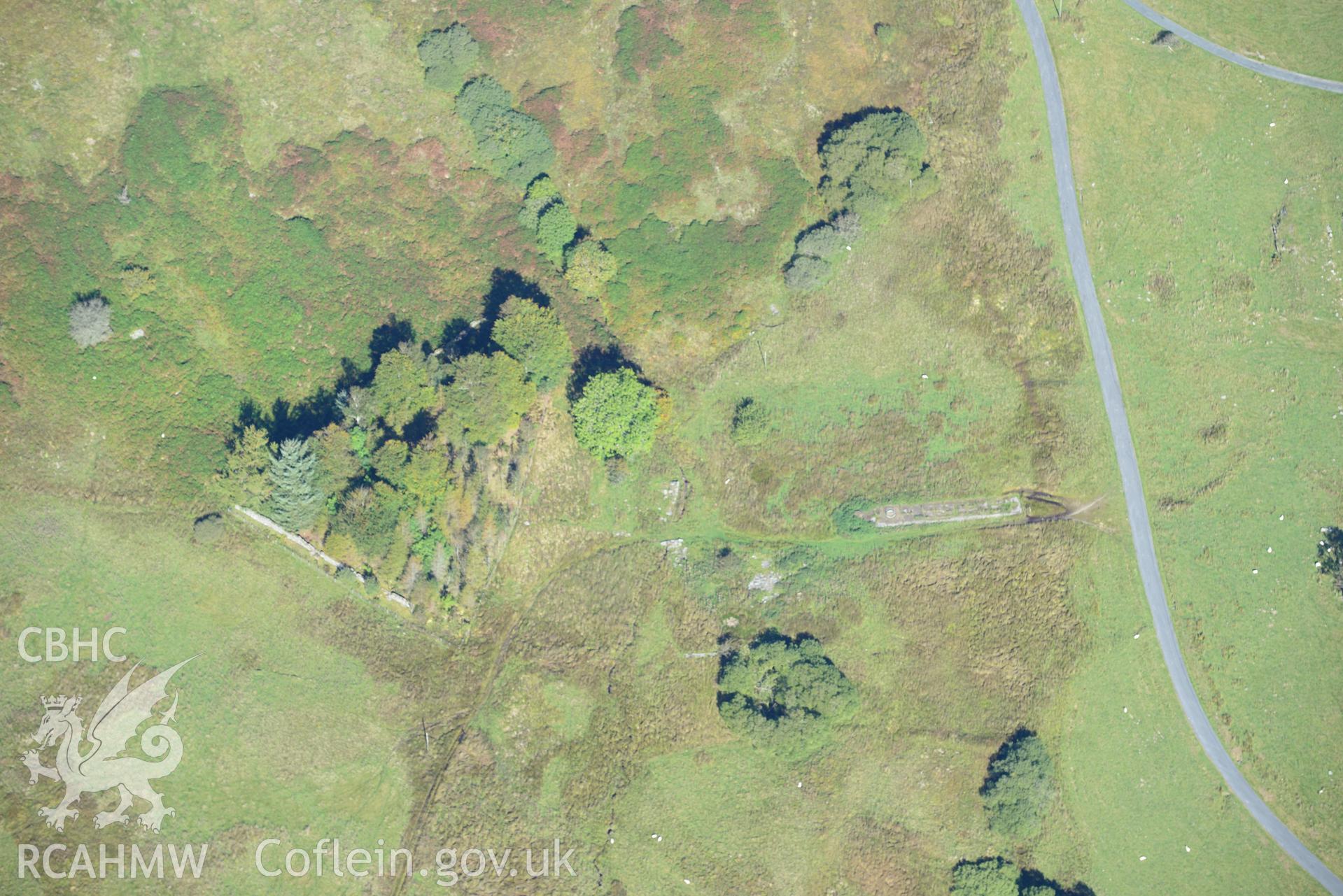 Concrete structure from Bronaber firing range and the earthworks of disused roads and trackways north west of Bedd Porus quarry, near Trawsfynydd. Oblique aerial photograph taken during the Royal Commission's programme of archaeological aerial reconnaissance by Toby Driver on 2nd October 2015.