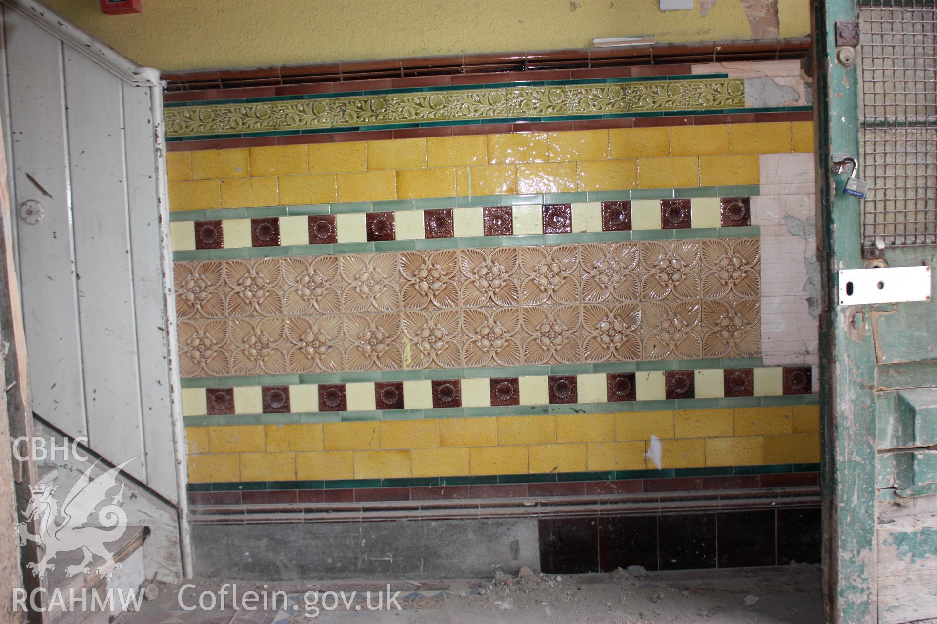 Colour photograph showing detail of tiled wall at base of stair at the Old Auction Rooms/ Liberal Club in Aberystwyth. Photographic survey conducted by Geoff Ward on 9th June 2010 during repair work prior to conversion into flats.