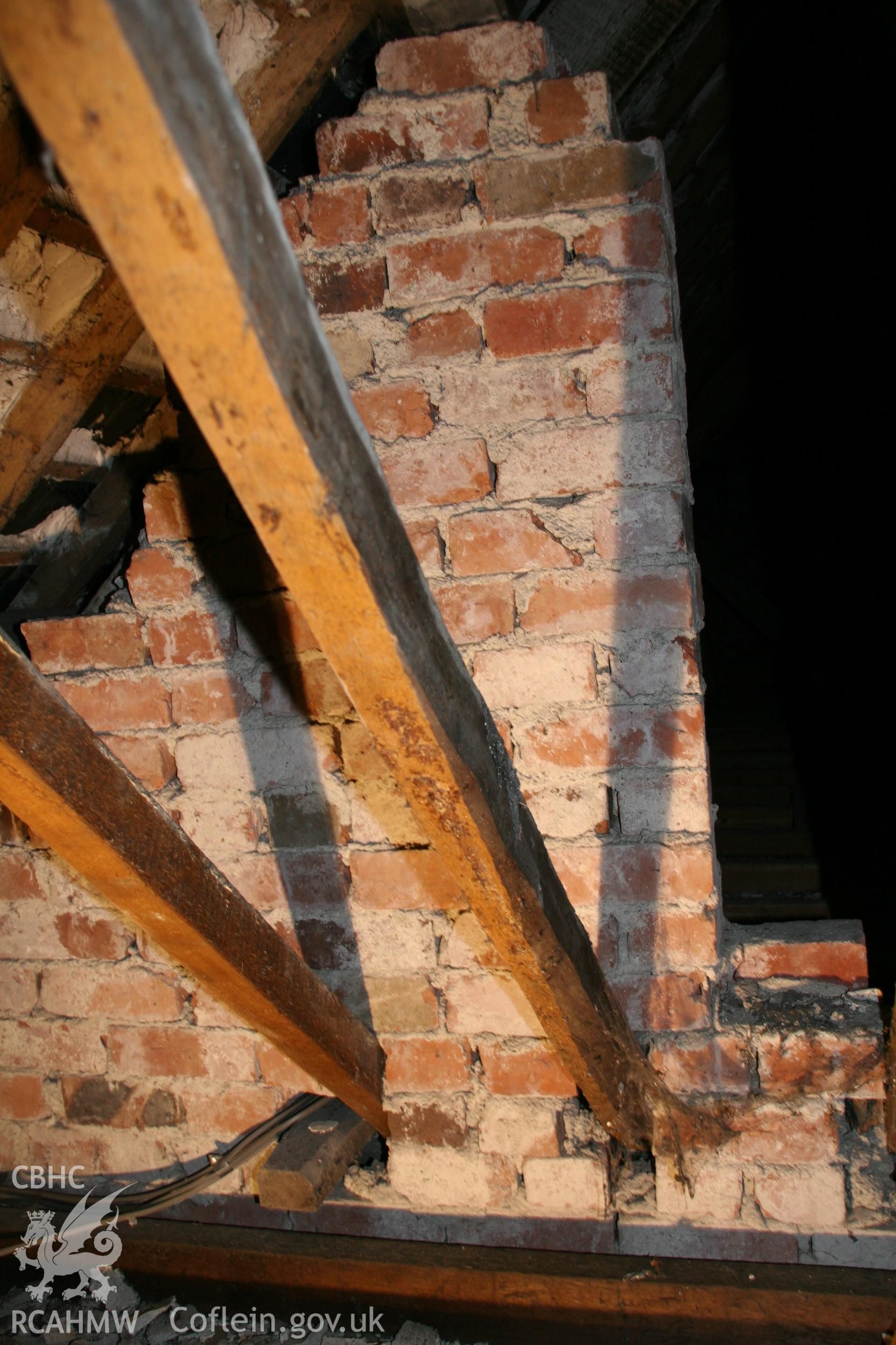 Photograph showing detailed interior view of brick wall & wooden beams in loft of former Llawrybettws Welsh Calvinistic Methodist chapel, Glanyrafon, Corwen. Taken by Tim Allen on 27th February 2019 to meet a condition attached to planning application.