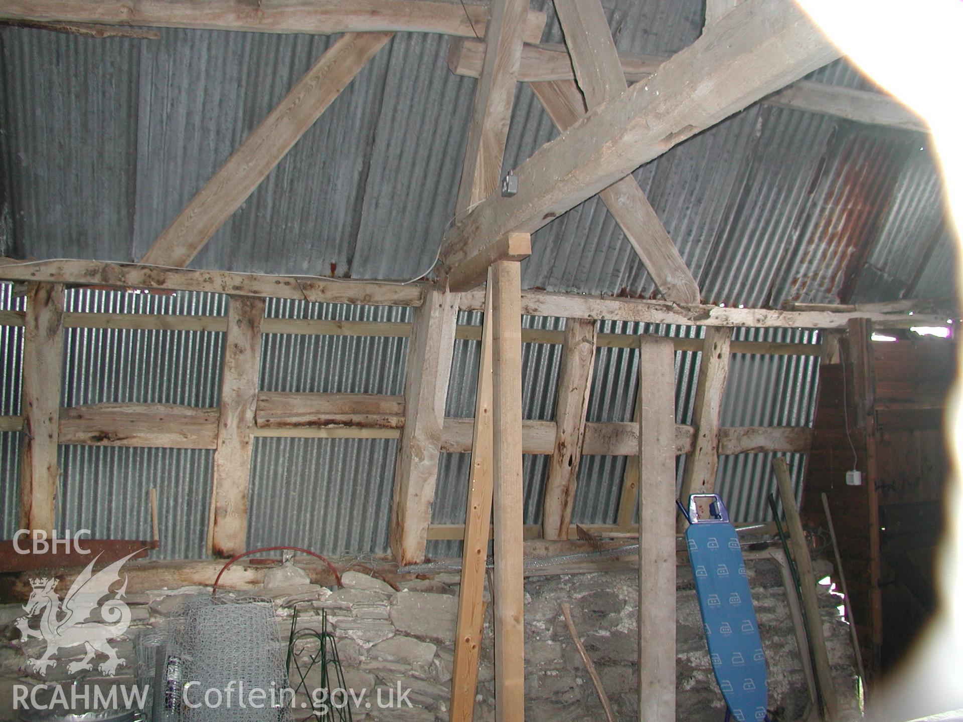 Interior view of barn or shed at Pistyll Gwyn showing timber frame, stone wall and corrugated iron roof. Photographic survey of Pistyll Gwyn Farmstead conducted by Geoff Ward on 13th November 2007.