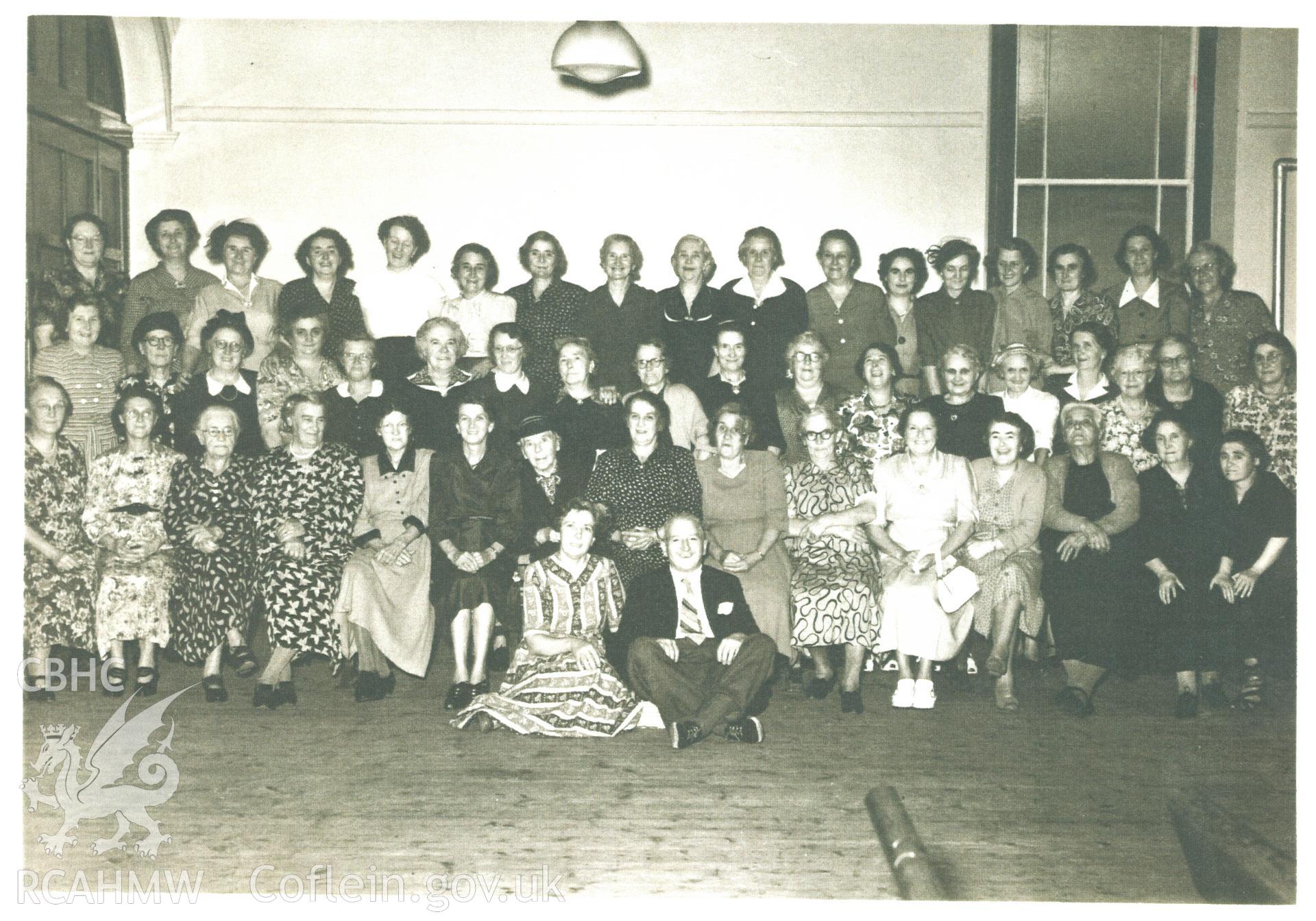 Black and white photograph of the Lady's Guild, in the vestry with Geraint Owen's wife, circa 1948 - 1949. Donated to the RCAHMW by Cyril Philips as part of the Digital Dissent Project.