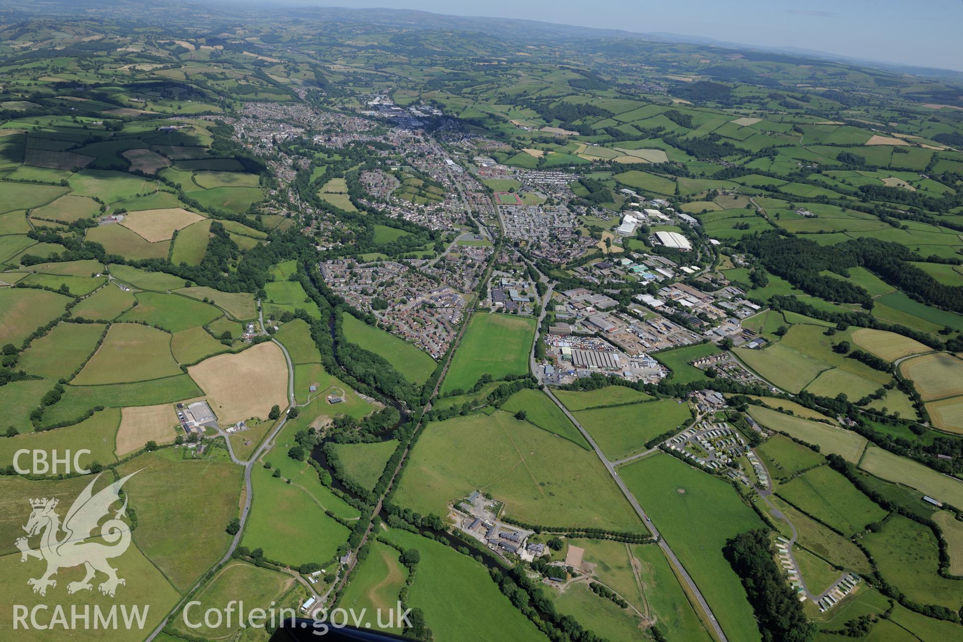 Glanhafren house and garden, the Roman road which runs through its grounds, and the town of Newtown beyond. Oblique aerial photograph taken during the Royal Commission's programme of archaeological aerial reconnaissance by Toby Driver on 30th June 2015.