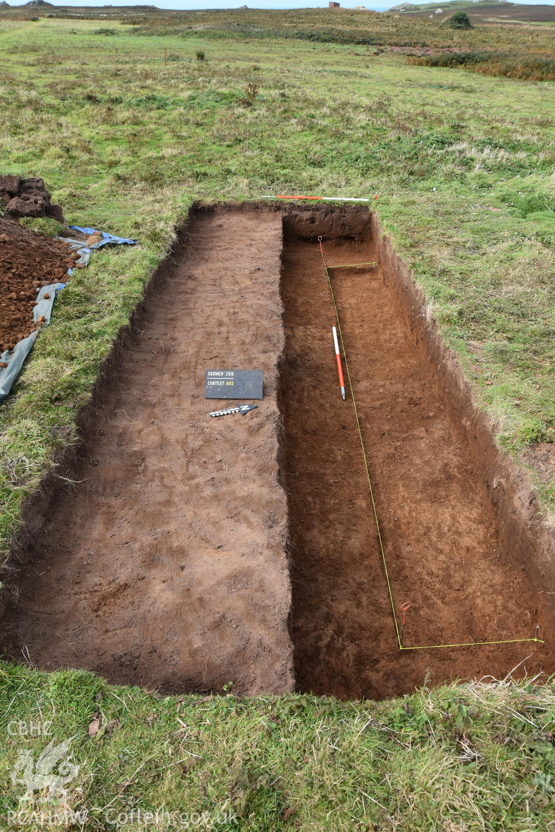 Investigator's photography showing the evaluation excavation of a geophysical anomaly in Well Meadow, Skomer Island, between 25-27th Sept 2018 as part of the Skomer Island Project. Trench from east at end of excavation.