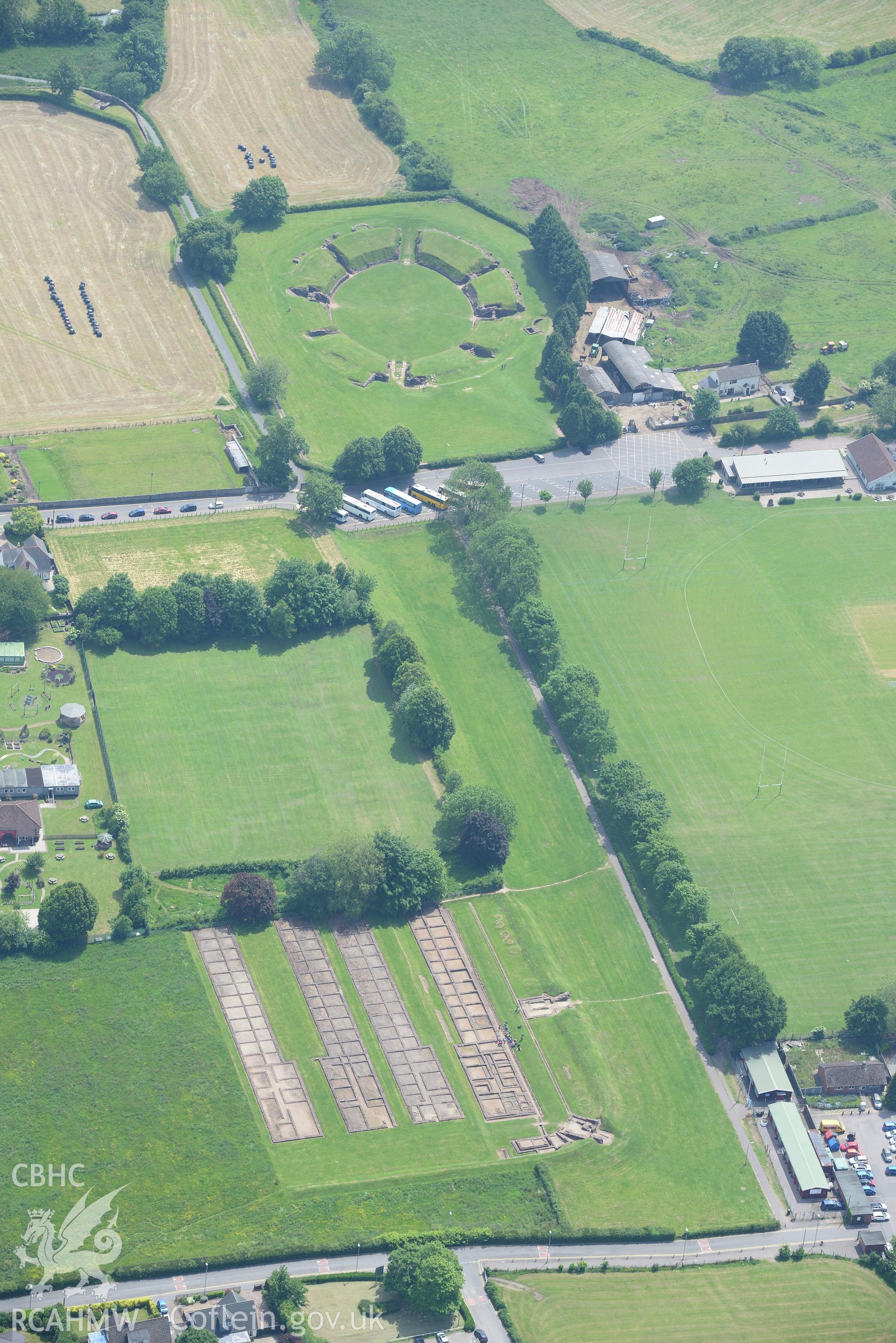 Caerleon town including views of the Roman barracks and amphitheatre. Oblique aerial photograph taken during the Royal Commission's programme of archaeological aerial reconnaissance by Toby Driver on 11th June 2015.