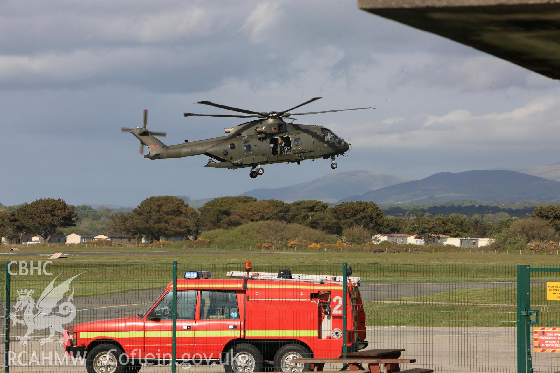 Roayl Air Force Merlin landing at Caernarfon airfield. Oblique aerial photograph taken during the Royal Commission?s programme of archaeological aerial reconnaissance by Toby Driver on 22nd May 2013.