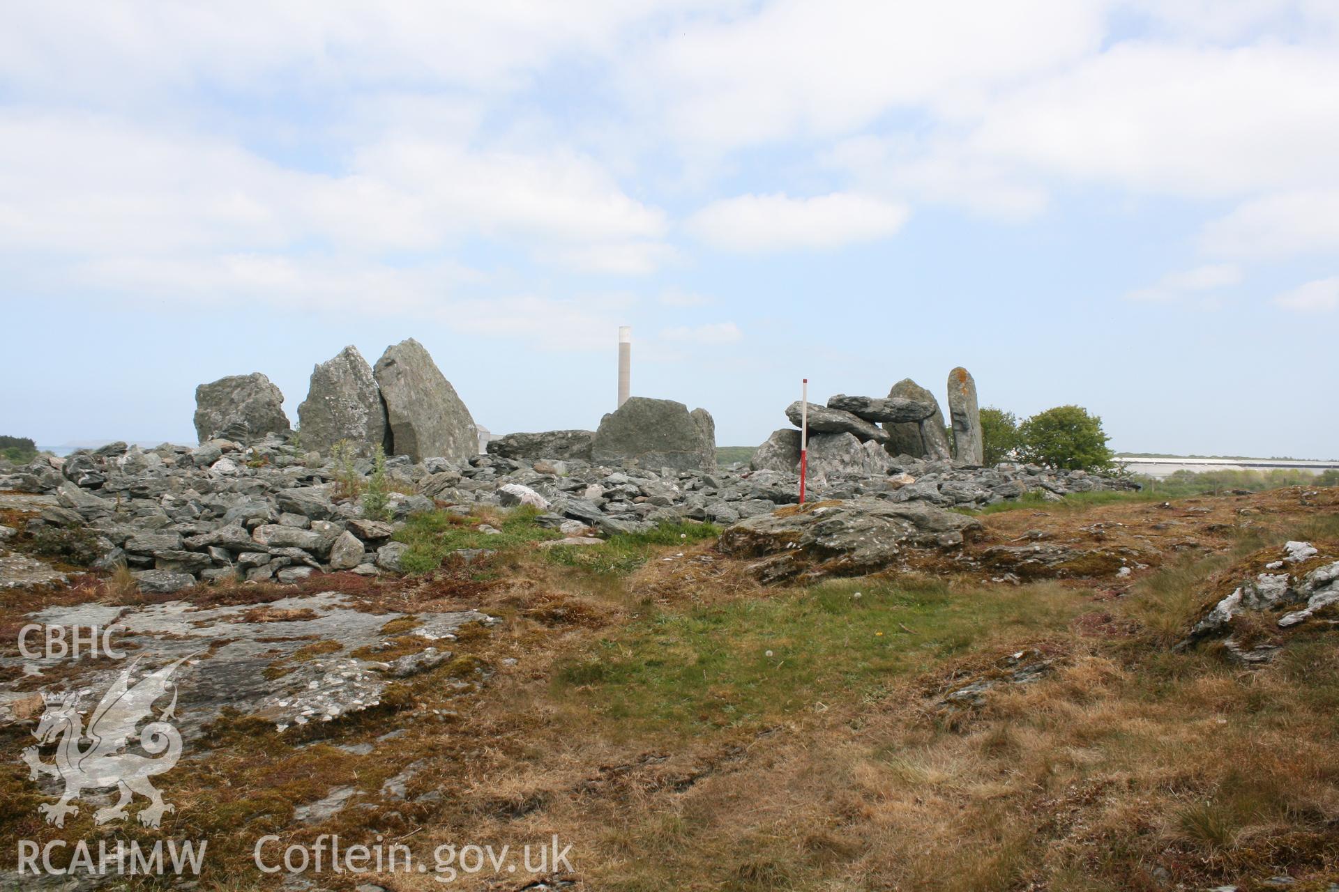 General view of Trefignath Chambered Tomb, with Holyhead aluminium works in the background. Digital photograph taken as part of archaeological work at Parc Cybi Enterprise Zone, Holyhead, Anglesey, carried out by Archaeology Wales, 2017. Project no: P2522.
