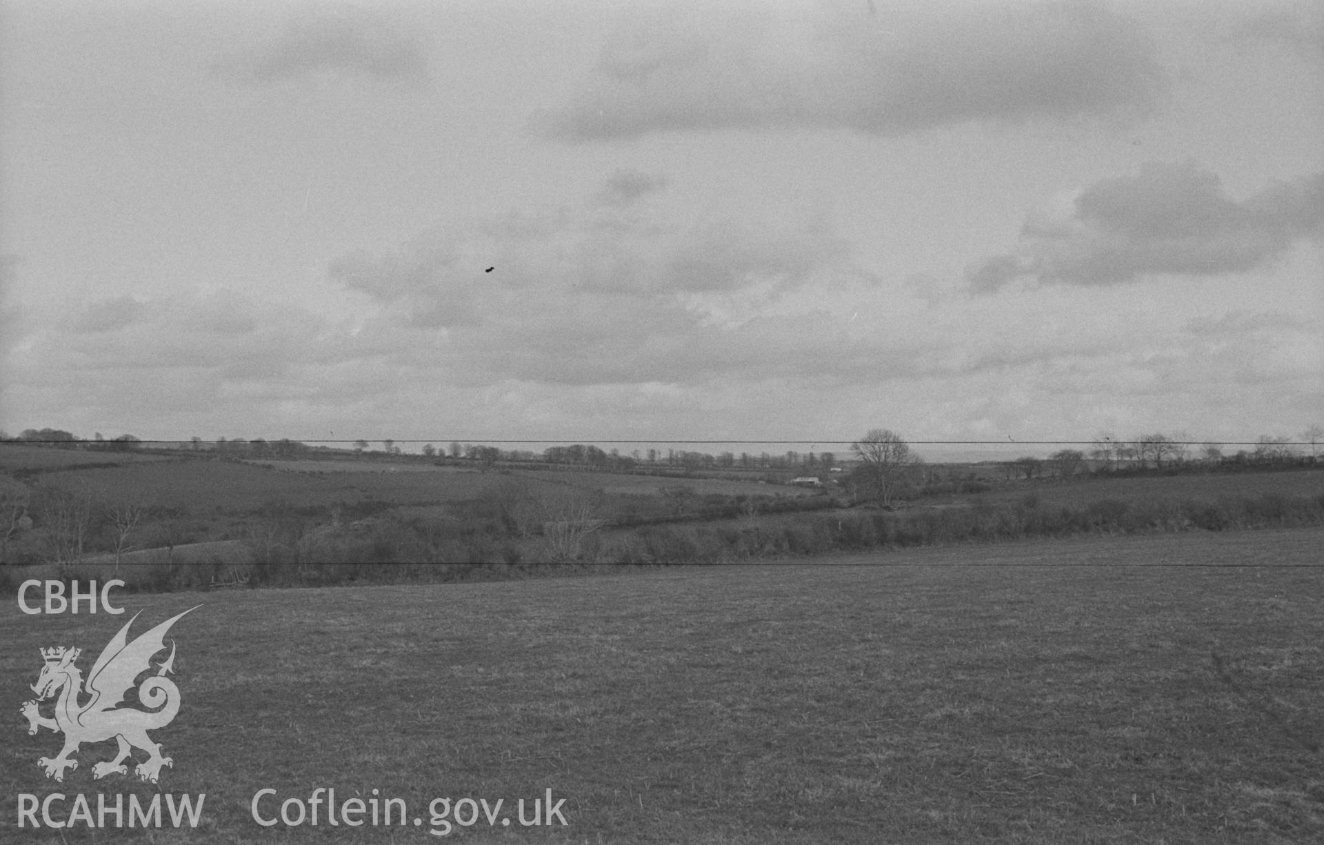 Digital copy of a black and white negative showing site of St Mary's church, Llanfair Trefhelygen. Photographed in April 1963 by Arthur O. Chater from Grid Reference SN 3412 4412, looking east.