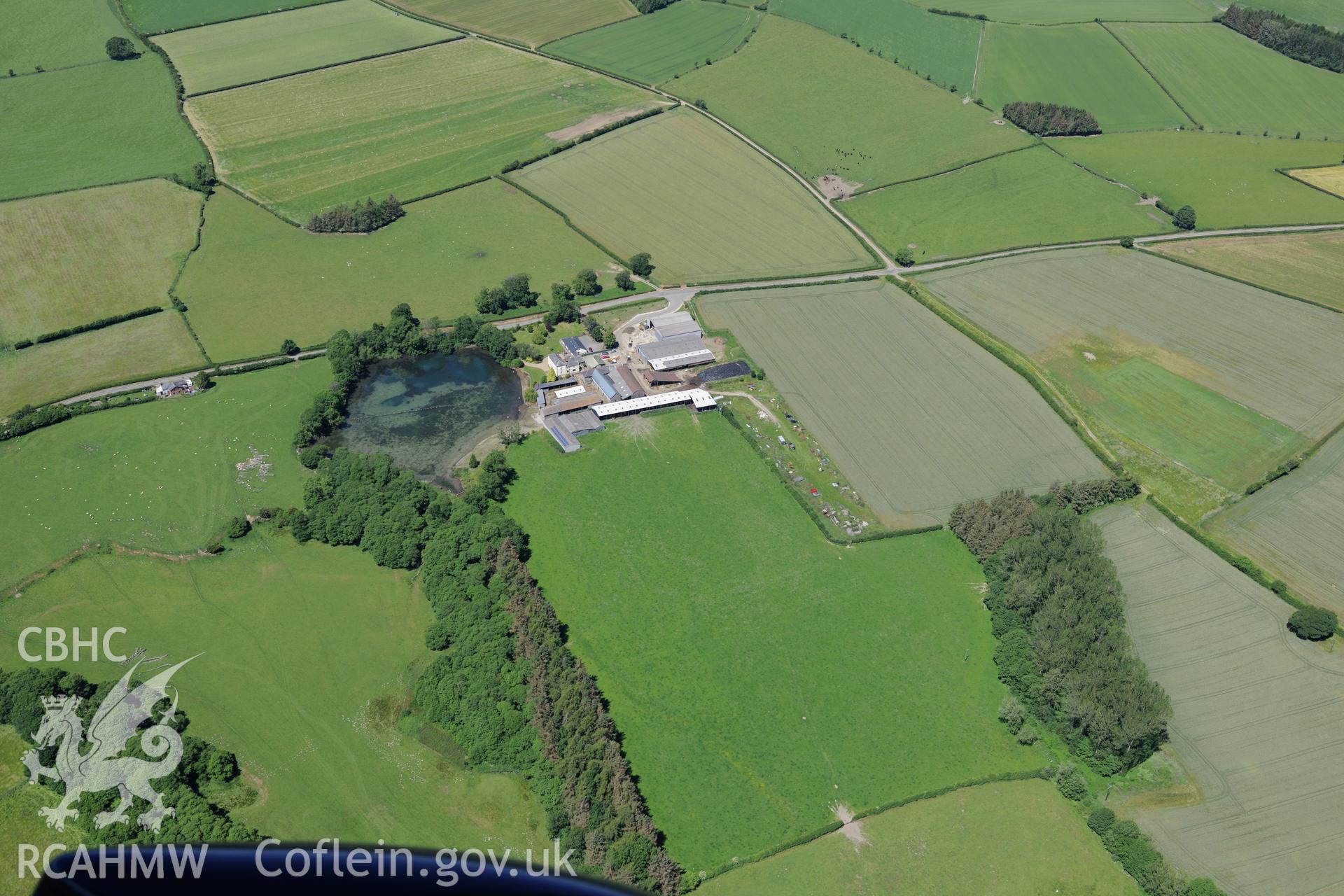 Hindwell farmstead and the roman fort in the field to the south east of the farm buildings, north west of Knighton. Oblique aerial photograph taken during the Royal Commission's programme of archaeological aerial reconnaissance by Toby Driver on 30th June 2015.