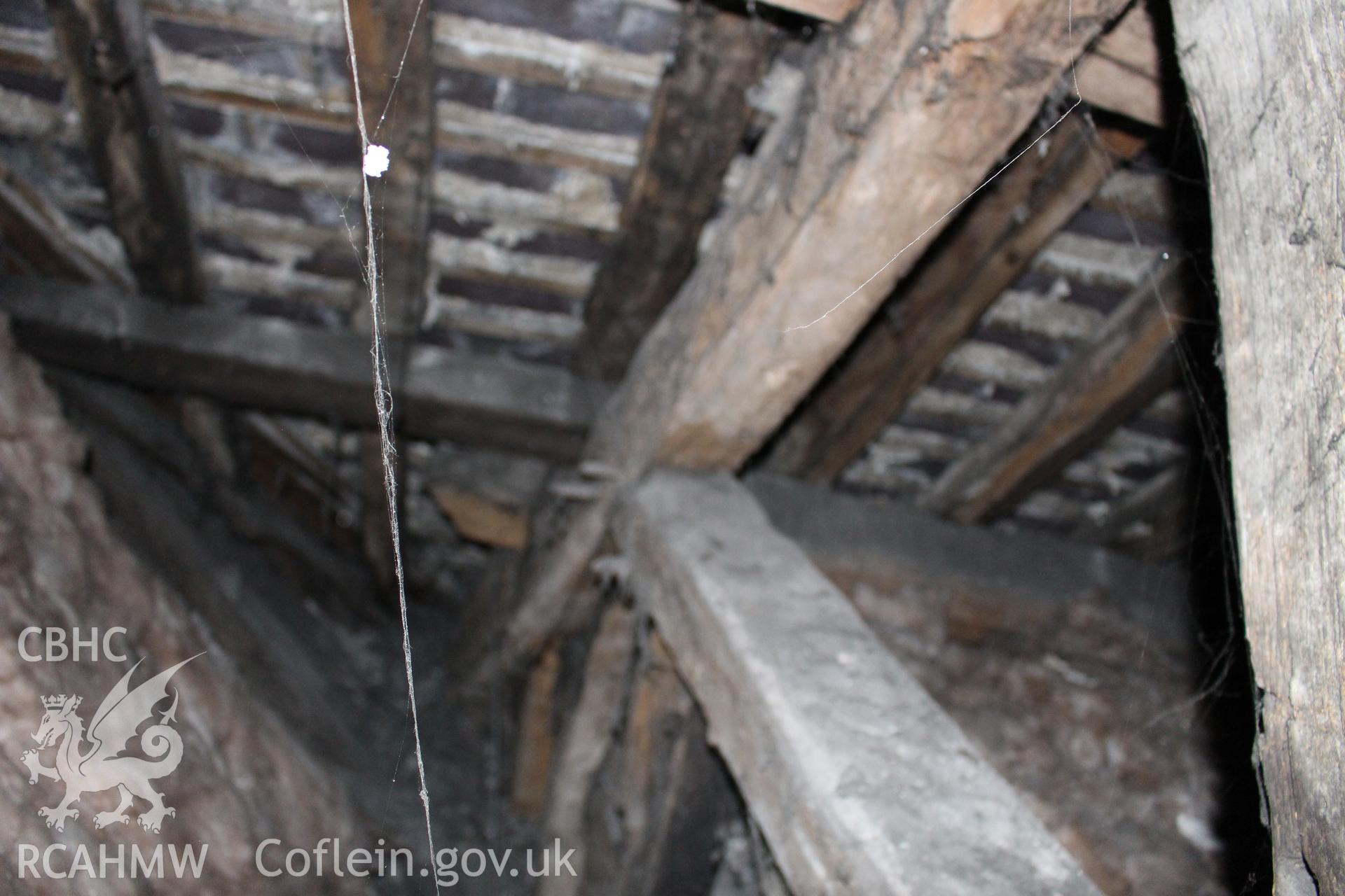 Colour photograph showing detail of insulating wool and timber roof frame at 5-7 Mwrog Street, Ruthin. Photographed during survey conducted by Geoff Ward on 14th May 2014.