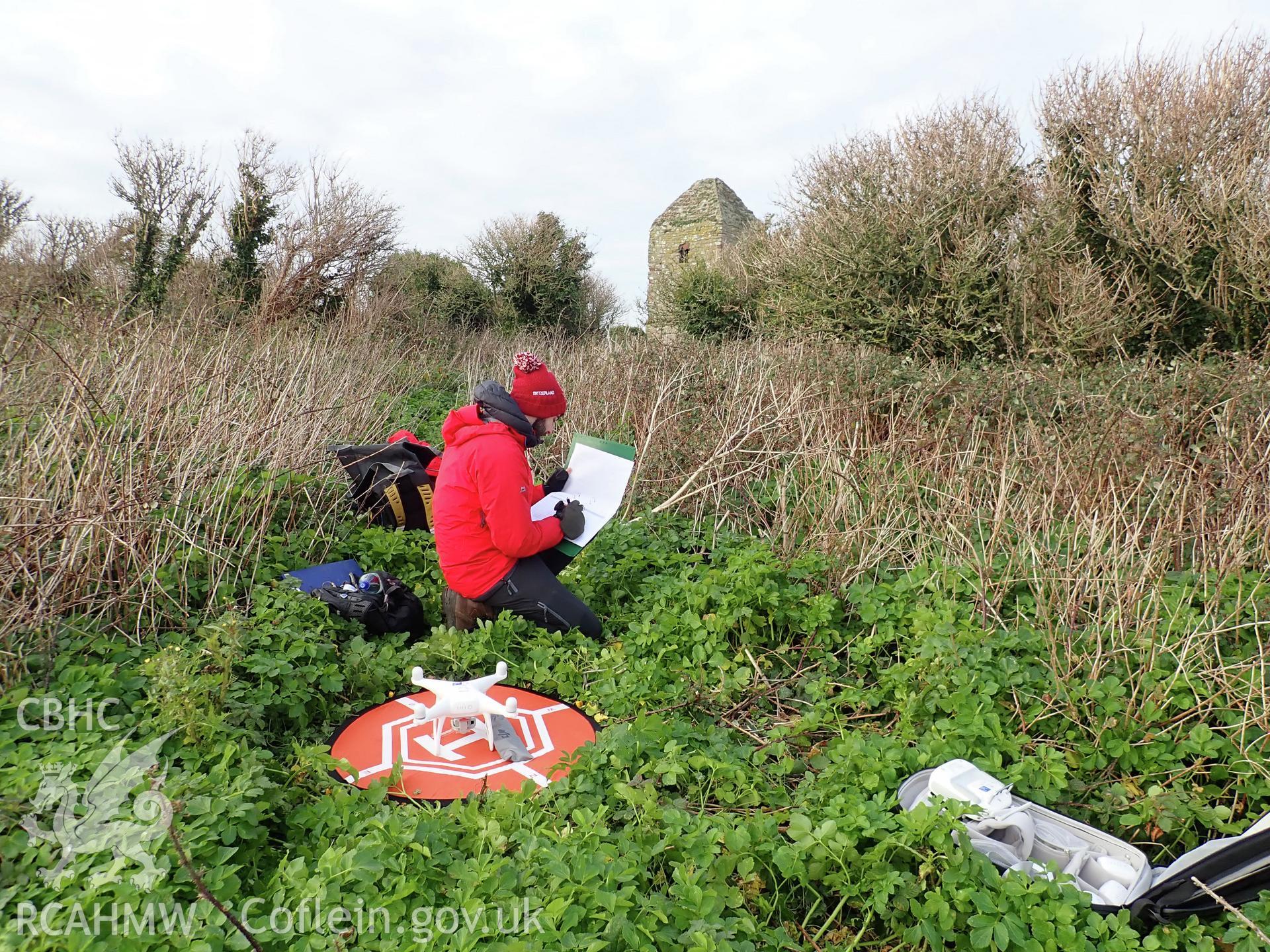 Drone/UAV survey in progress by Dan Hunt on the church on Puffin Island or Ynys Seiriol, 26 November 2018 for the CHERISH Project. ? Crown: CHERISH PROJECT 2018. Produced with EU funds through the Ireland Wales Co-operation Programme 2014-2020. All material made freely available through the Open Government Licence.