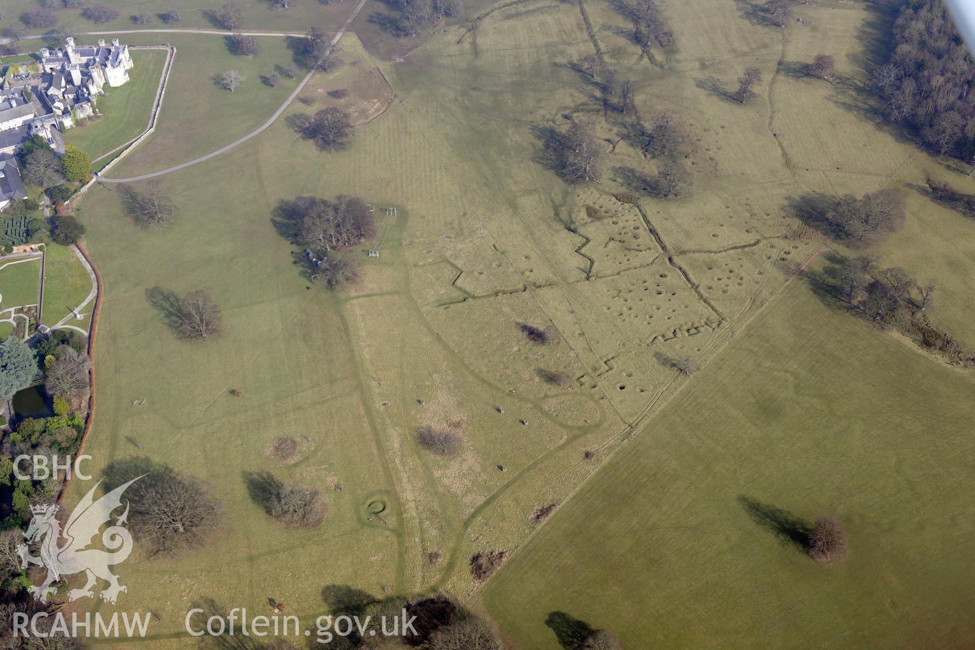 Bodelwyddan Castle, its garden, and Bodelwyddan Park army practise trenches, west of St. Asaph. Oblique aerial photograph taken during the Royal Commission?s programme of archaeological aerial reconnaissance by Toby Driver on 28th February 2013.