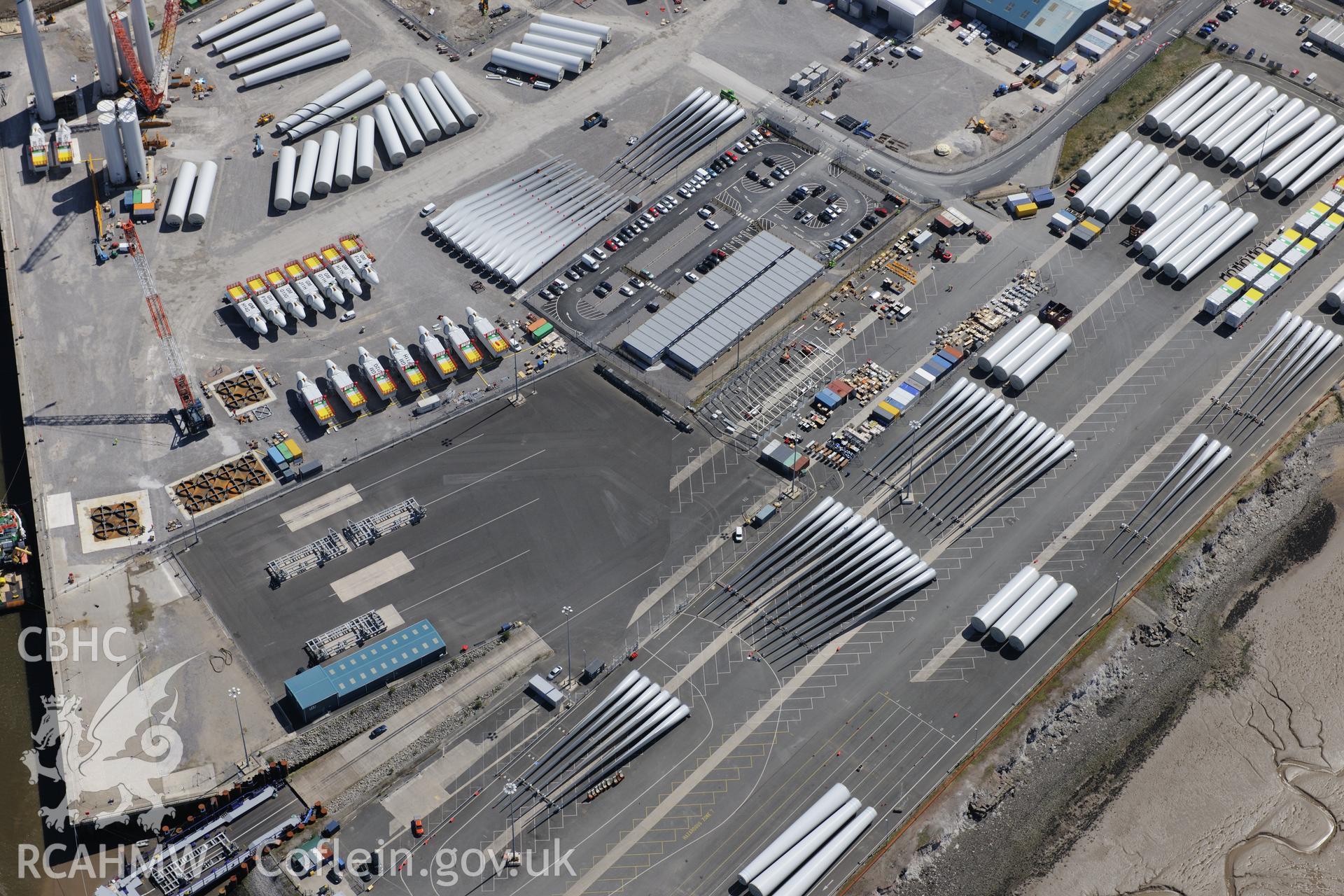 Mostyn Quay in the port of Mostyn, with windfarm parts. Oblique aerial photograph taken during the Royal Commission?s programme of archaeological aerial reconnaissance by Toby Driver on 22nd May 2013.