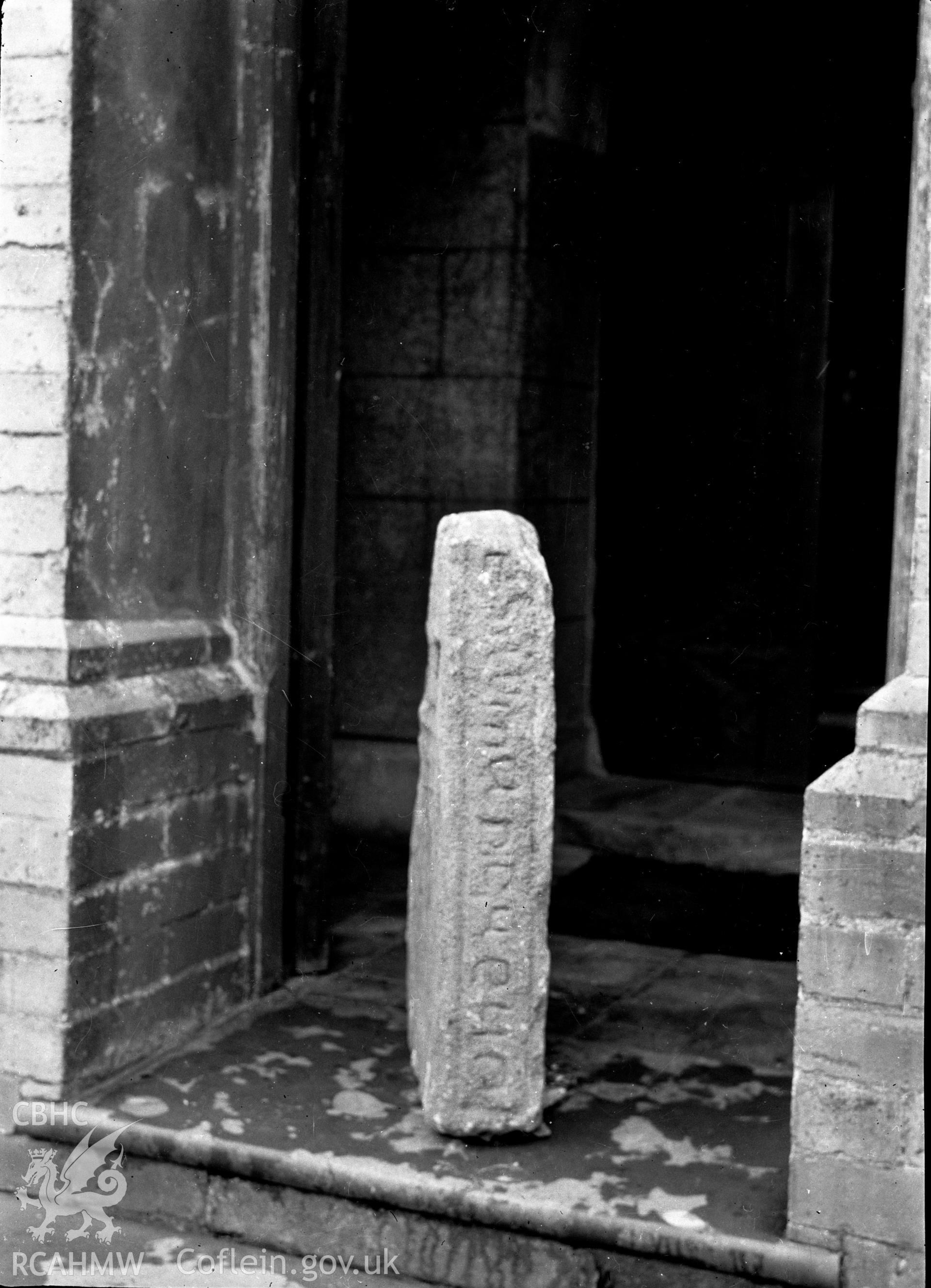 Digital copy of a nitrate negative showing an inscribed stone in the chapel on Bardsey Island. Transcript of reverse of black and white photograph: 'Bardsey Island / Caernarvon / 57 x 6.' From the Cadw Monuments in Care Collection.
