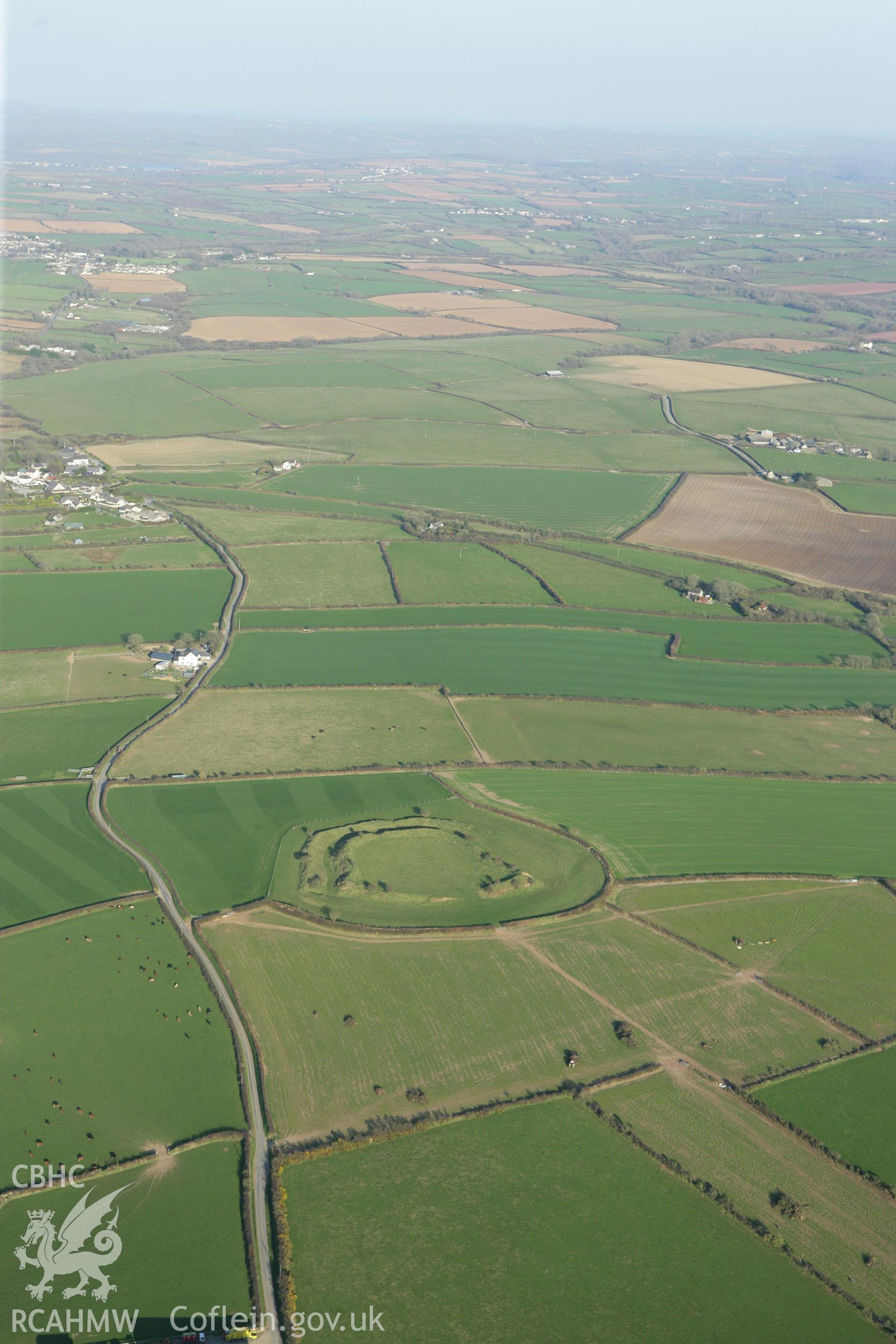 RCAHMW colour oblique aerial photograph of Romans Castle. A wide landscape view. Taken on 13 April 2010 by Toby Driver