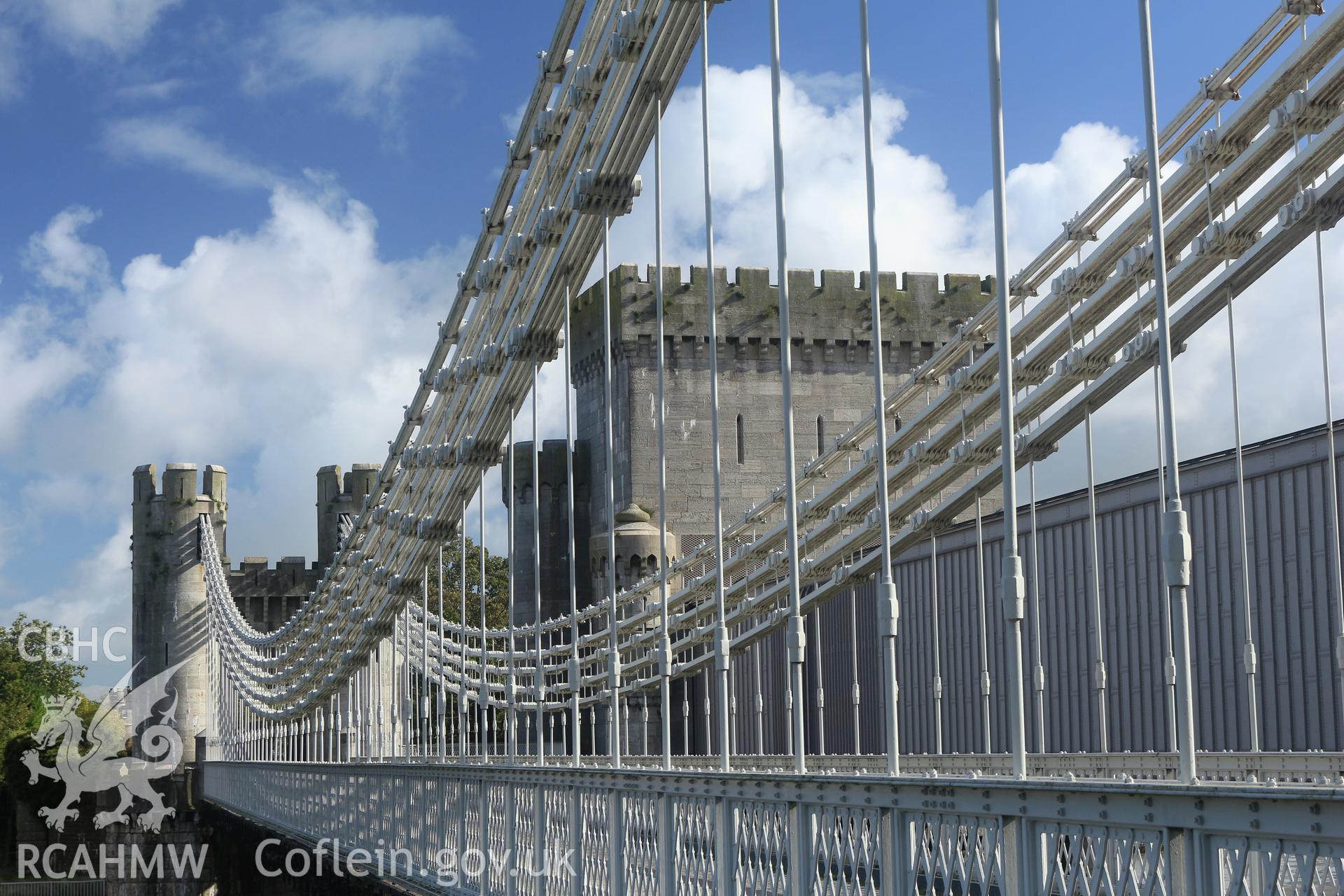 Investigator Photographs of Conwy Suspension Bridge. Centre span, chain and suspension cables as seen from the castle side; Stephenson's tubular railway bridge in the background.