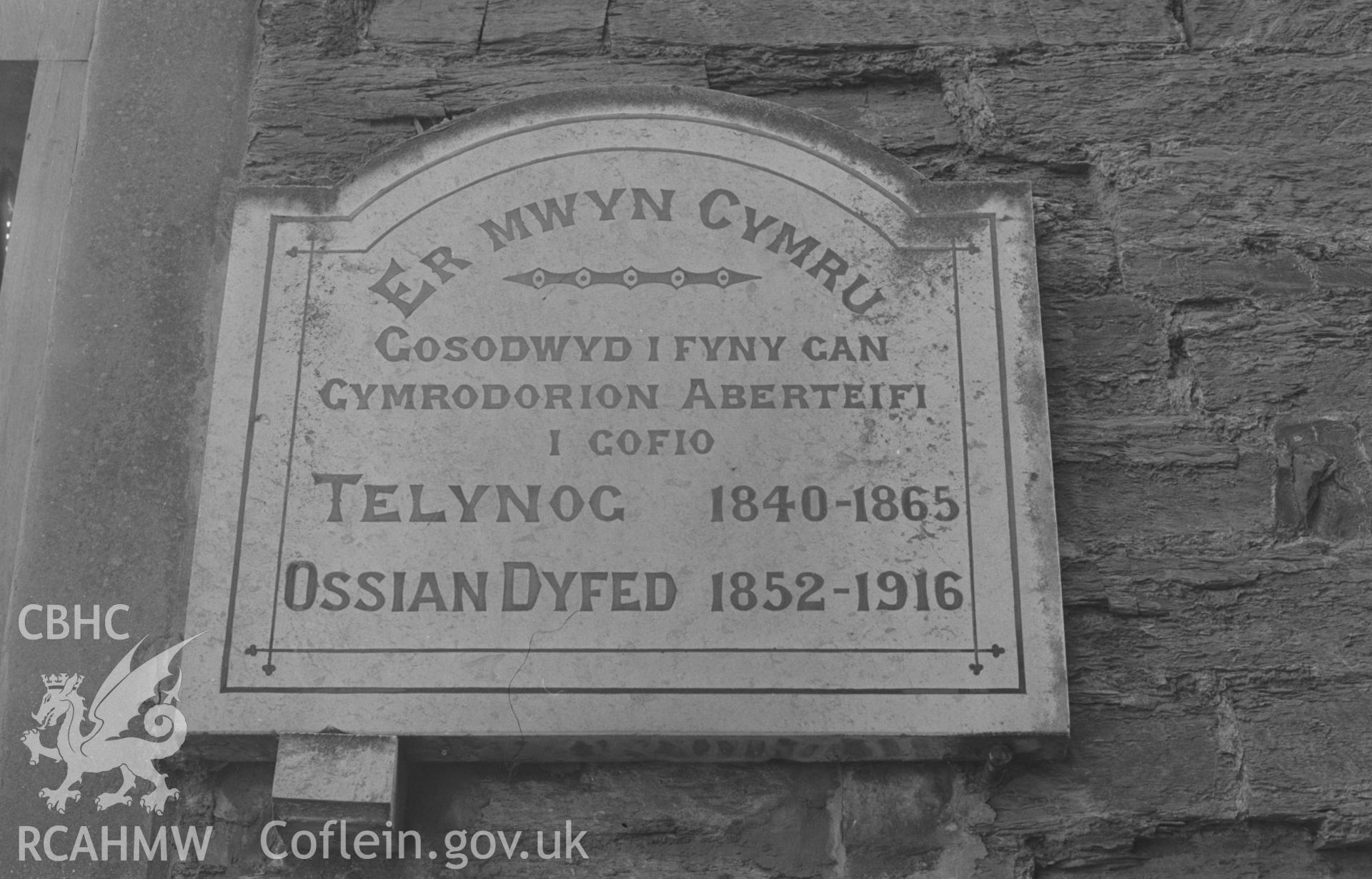 Digital copy of a black and white negative showing memorial plaque (unveiled in 1927 to the memory of Telynog and Ossian Dyfed) at the entrance to Eben's Lane, Cardigan. Photographed by Arthur O. Chater on 9th April 1968 looking south from SN 178 461.