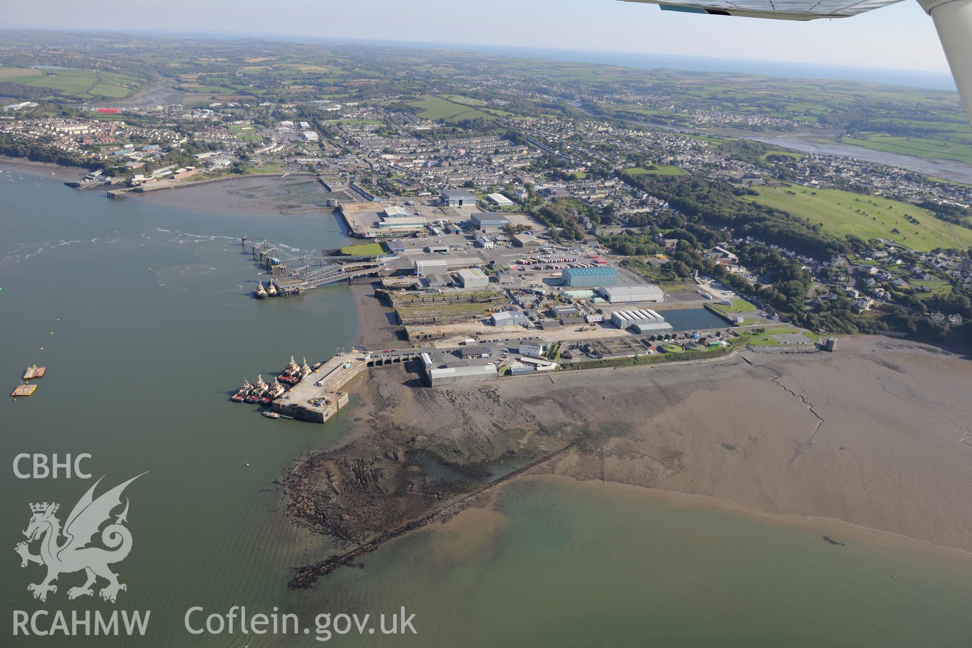 The town of Pembroke Dock, including views of the dock, ferry terminal and dry dock. Oblique aerial photograph taken during the Royal Commission's programme of archaeological aerial reconnaissance by Toby Driver on 30th September 2015.